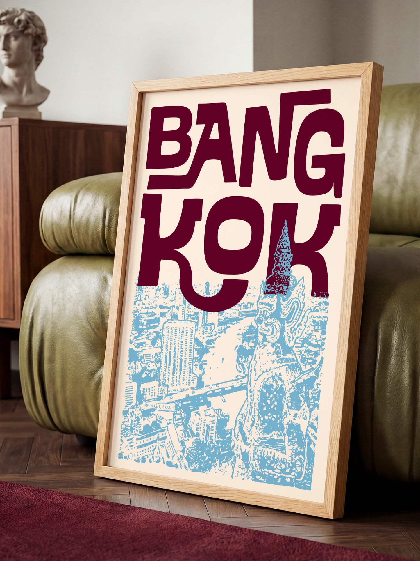 A framed poster with the text "BANG KOK" prominently displayed, featuring an illustration of a cityscape.