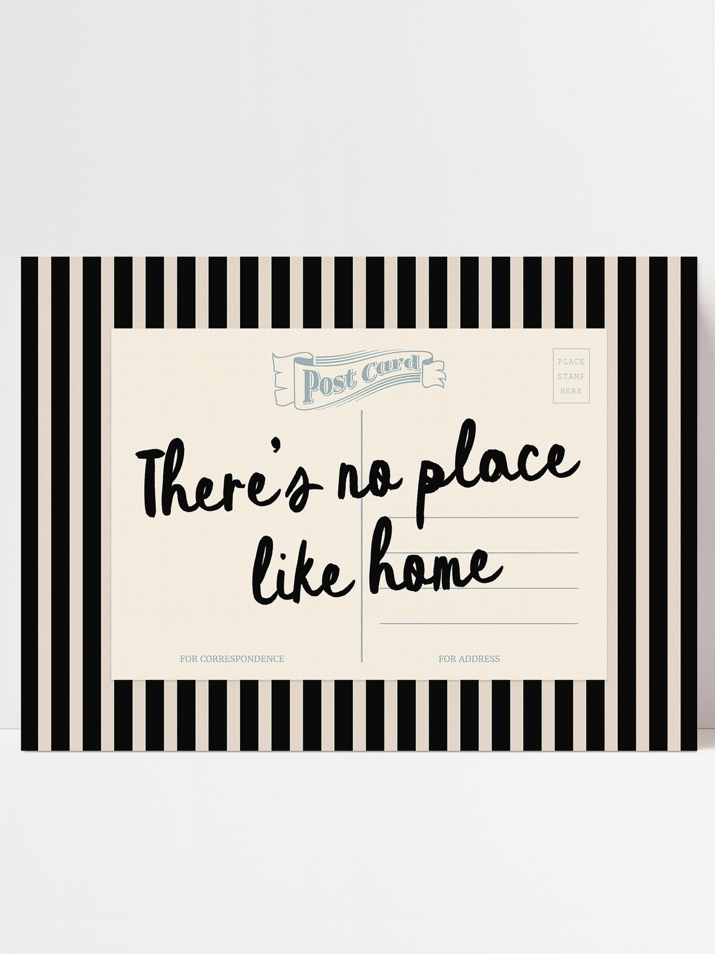 The image is a postcard with a black and white striped border and a handwritten message that reads "There's no place like home".
