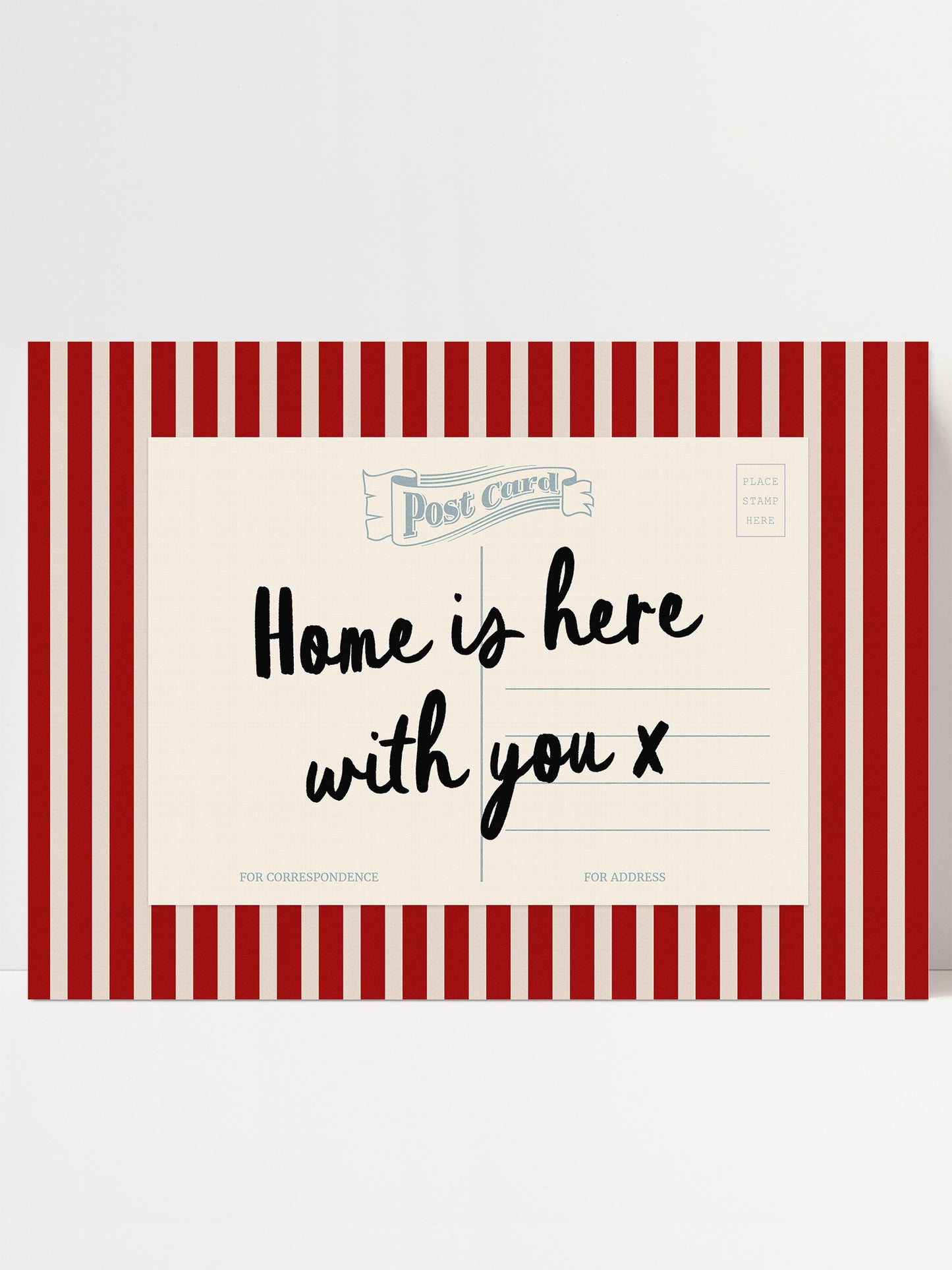 A postcard with a red and white striped border, featuring the text "Home is here with you x" in a handwritten style.