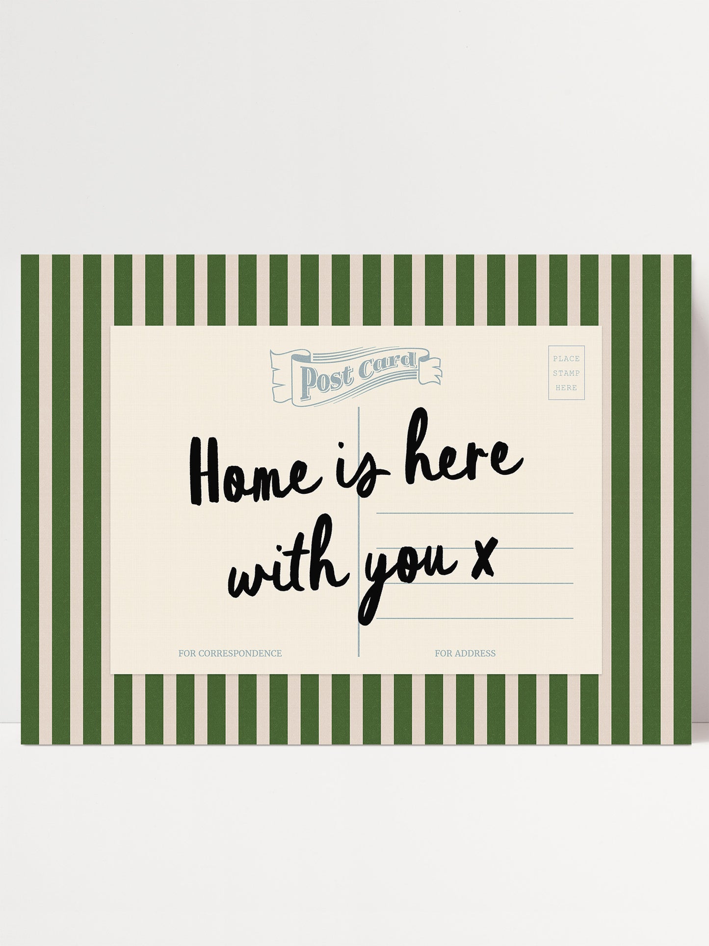 A postcard with a green and white striped border, featuring the text "Home is here with you x" in black cursive font.