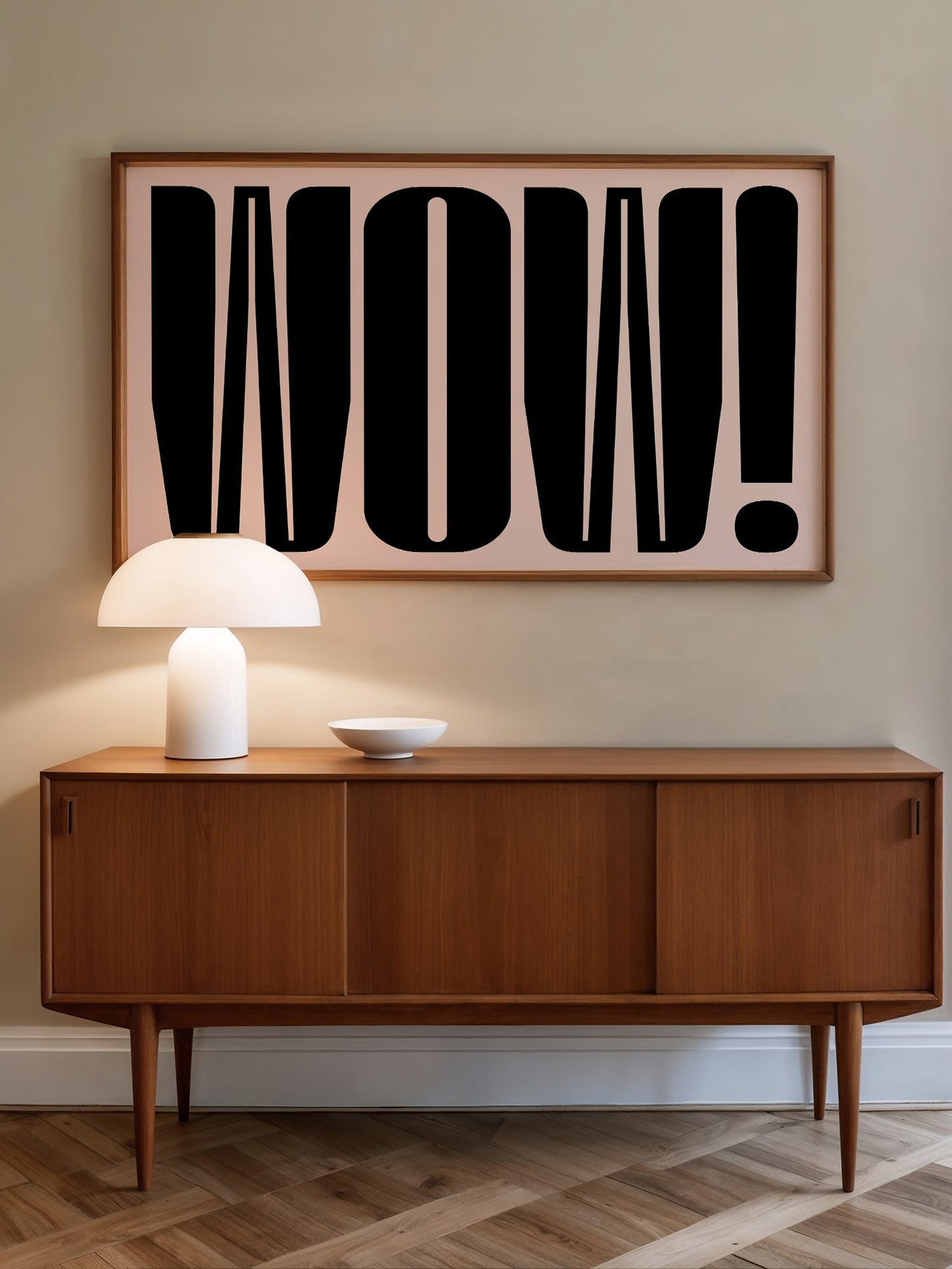 a wooden cabinet with a white lamp on top, and a large framed text on the wall above it that says "WOW!".