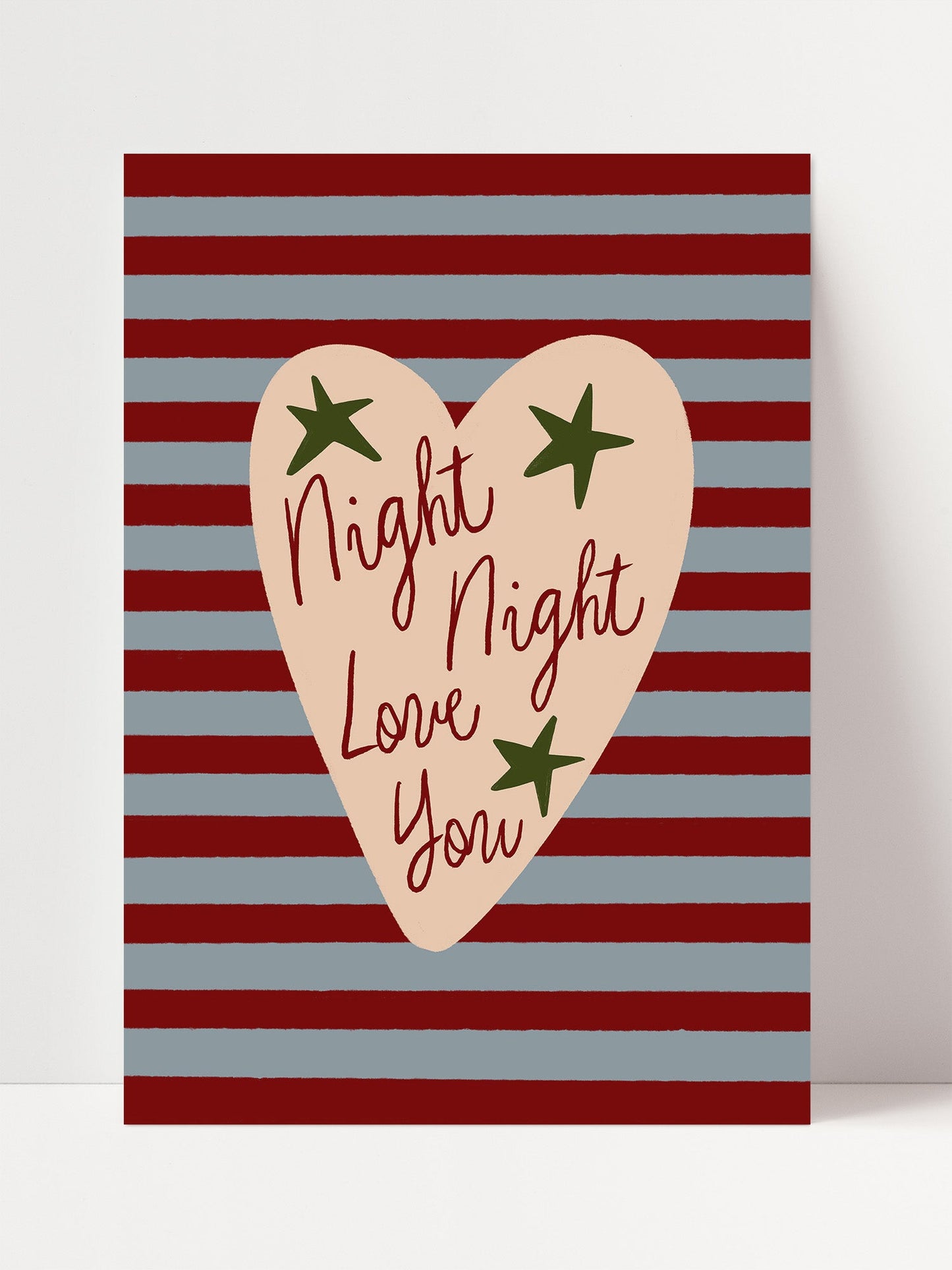 a heart-shaped graphic with the text "Night, Night, Love You" written inside it, set against a background of red and blue stripes.