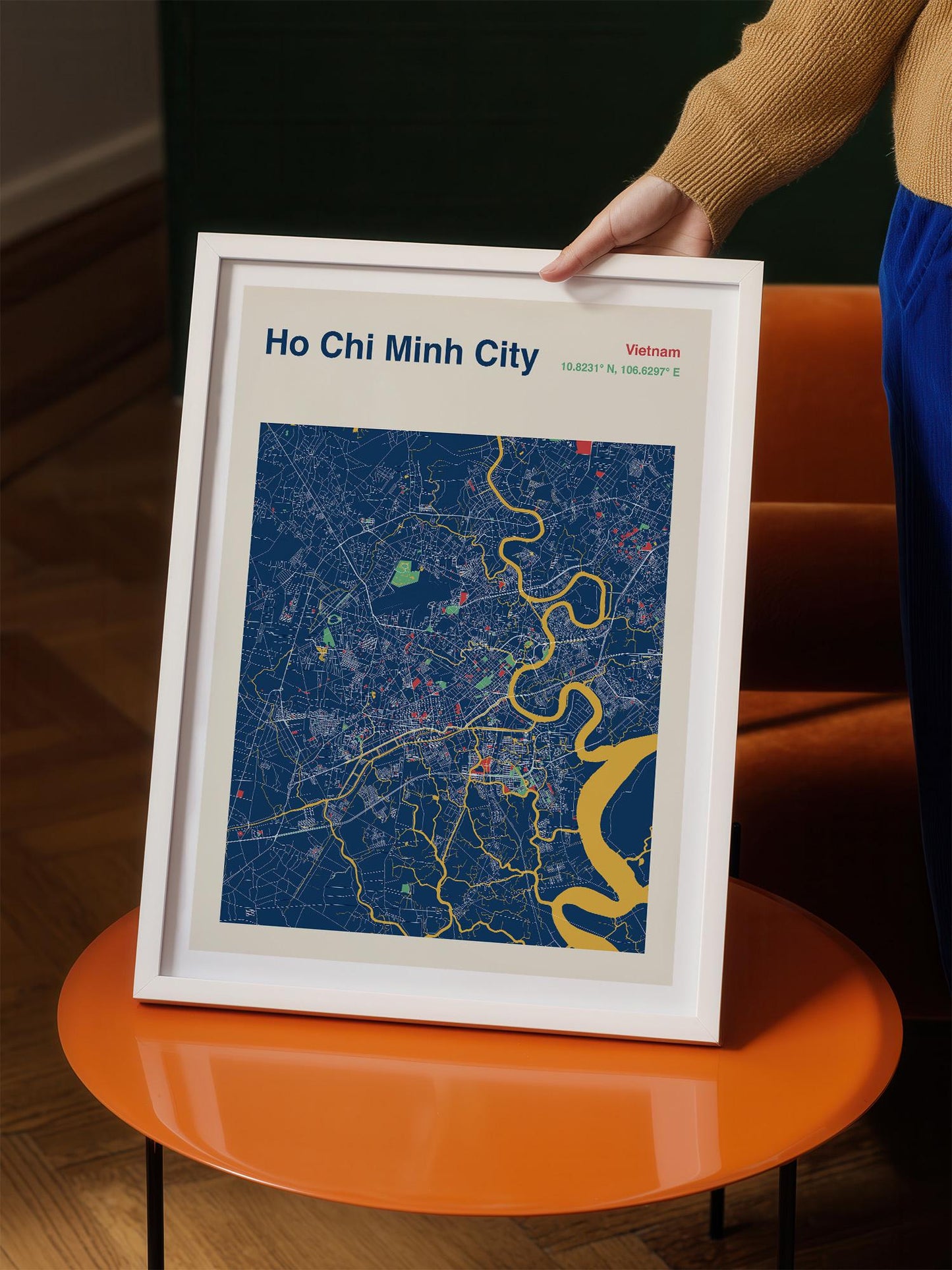 A person is holding a framed map of Ho Chi Minh City, Vietnam, which is a map of the city of Ho Chi Minh City, Vietnam.