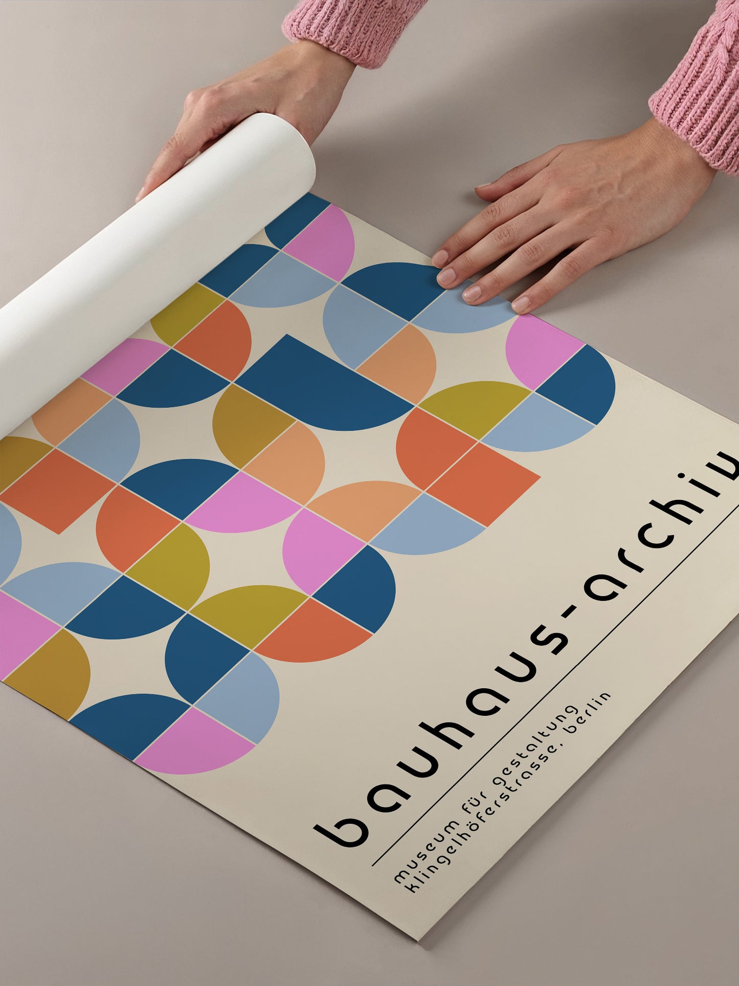 a poster for the Bauhaus-architecture museum in Berlin, Germany. The poster displays a geometric pattern of circles and rectangles in various colors, including pink, blue, orange, and yellow. The text on the poster reads "Bauhaus-architecture" and "Museum für gestlätung nicht geschätzt", which translates to "Bauhaus-architecture Museum not just a place of gestlätung".