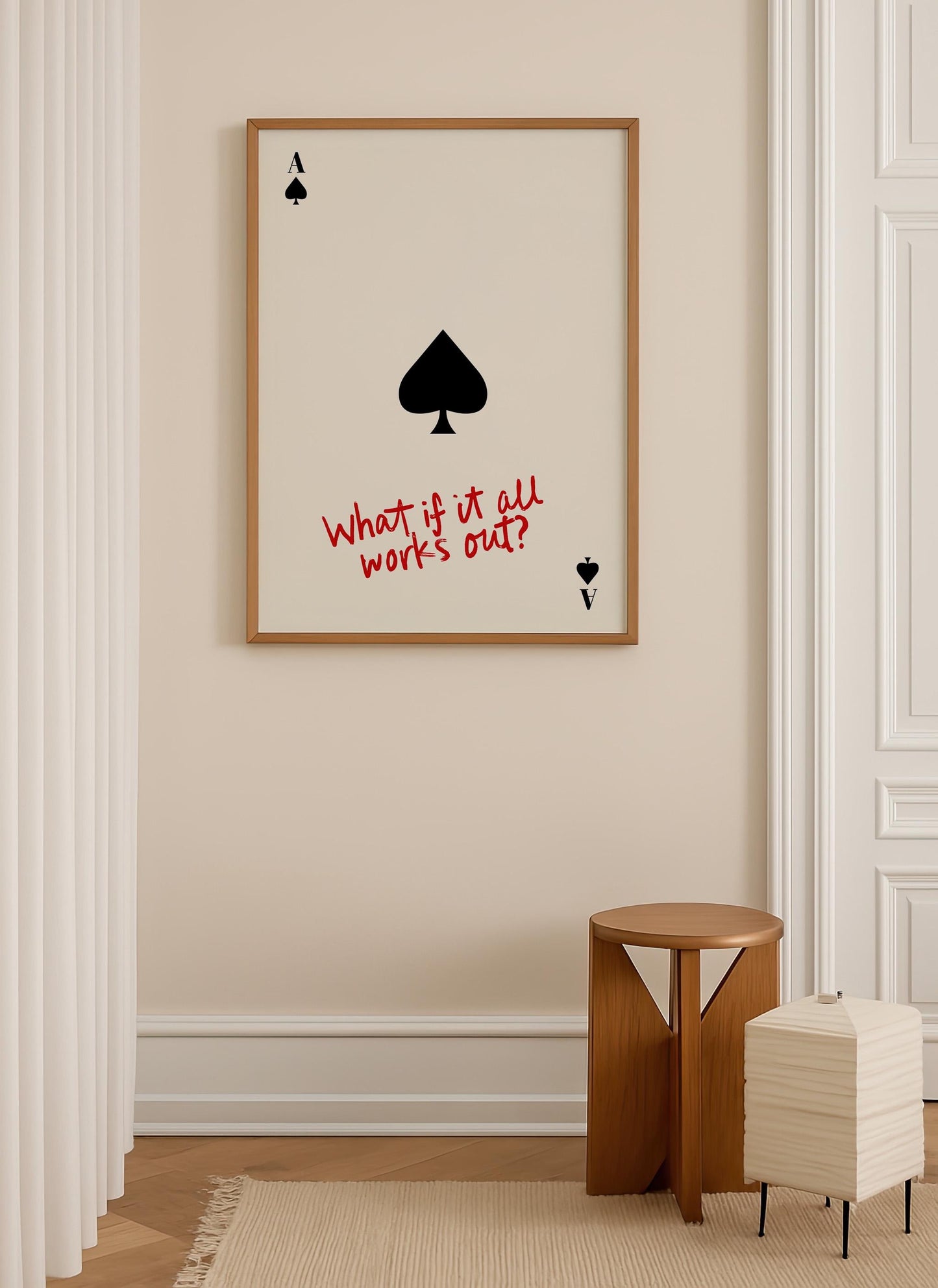 a framed poster with a spade symbol and the text "What if it all works out?" displayed on a wall.