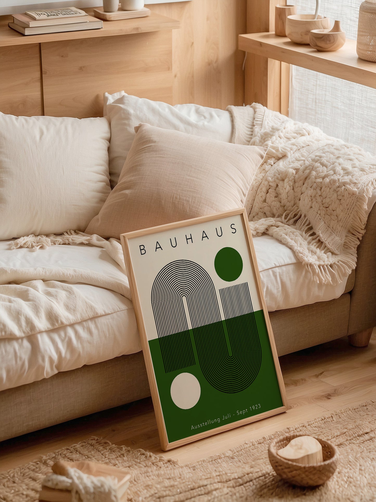 a framed poster of the Bauhaus design school, with a cozy living room setting in the background.