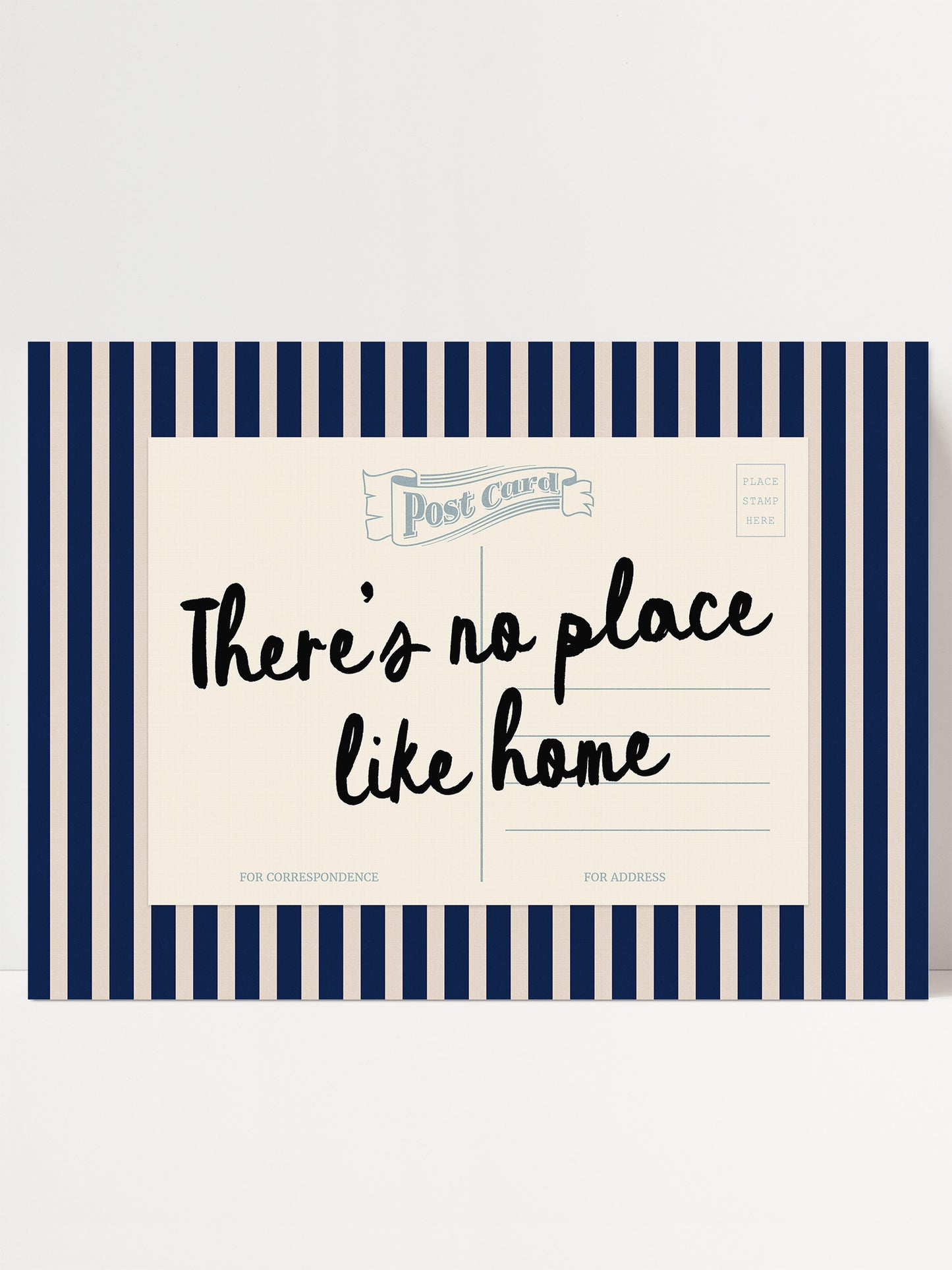 The image is a postcard with a blue and white striped border. The postcard has a message that reads "There's no place like home" in black cursive text.