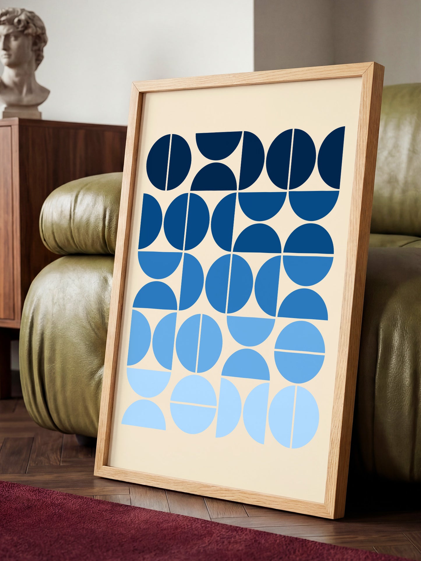 a framed artwork with a geometric design of blue circles and lines on a beige background.