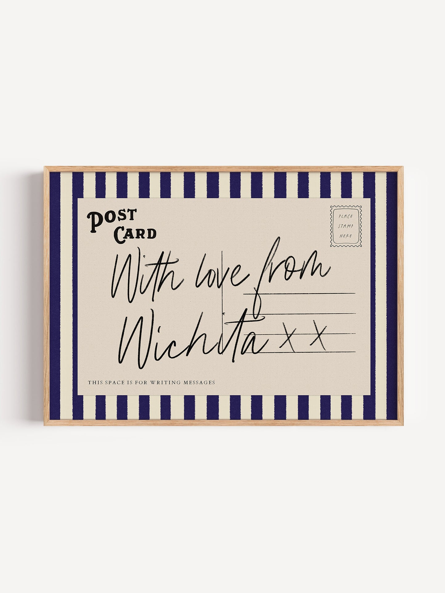 A framed postcard with a handwritten message that reads "With love from Wichita x".