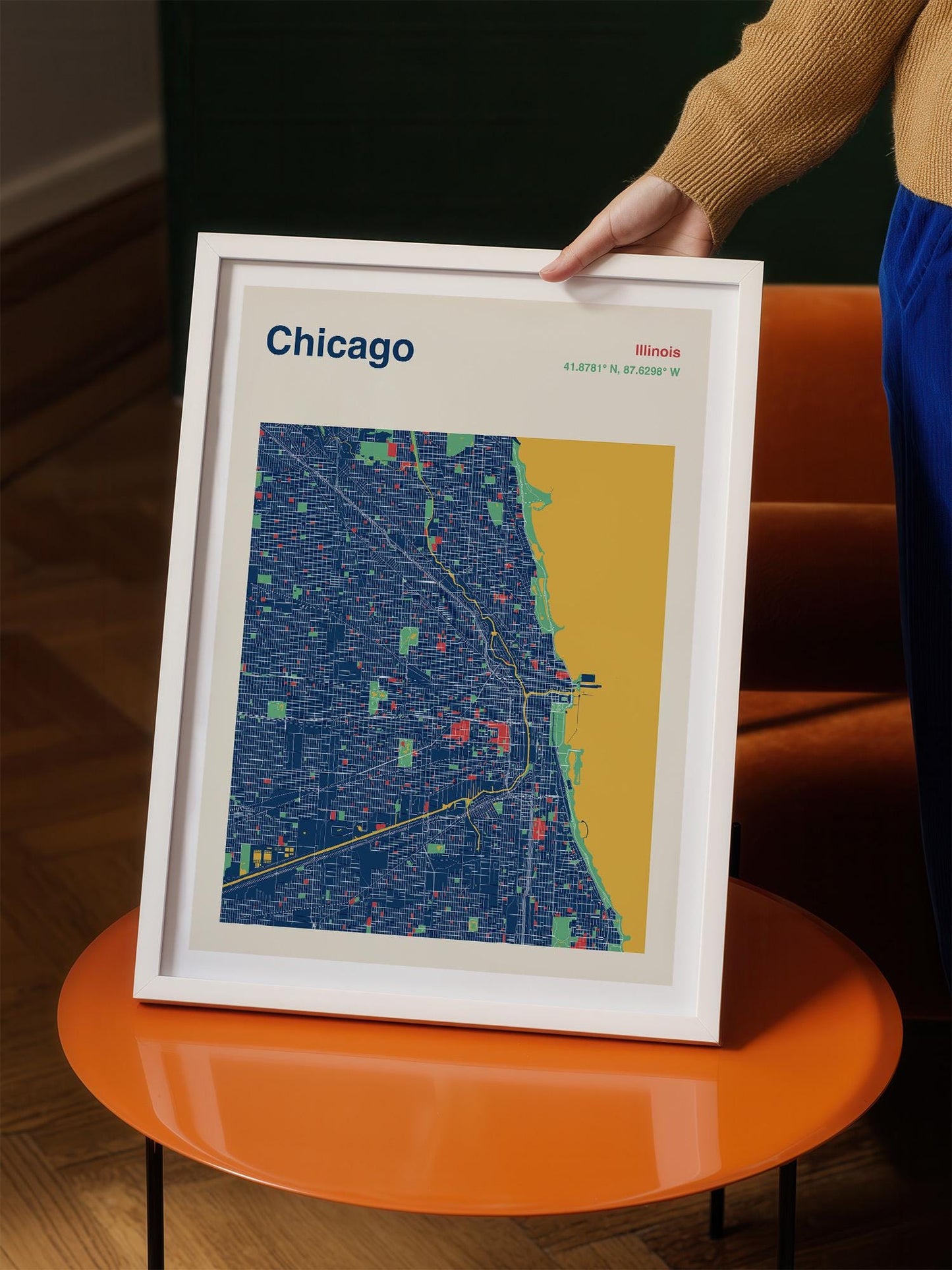 A person is holding a framed map of Chicago, Illinois, United States.