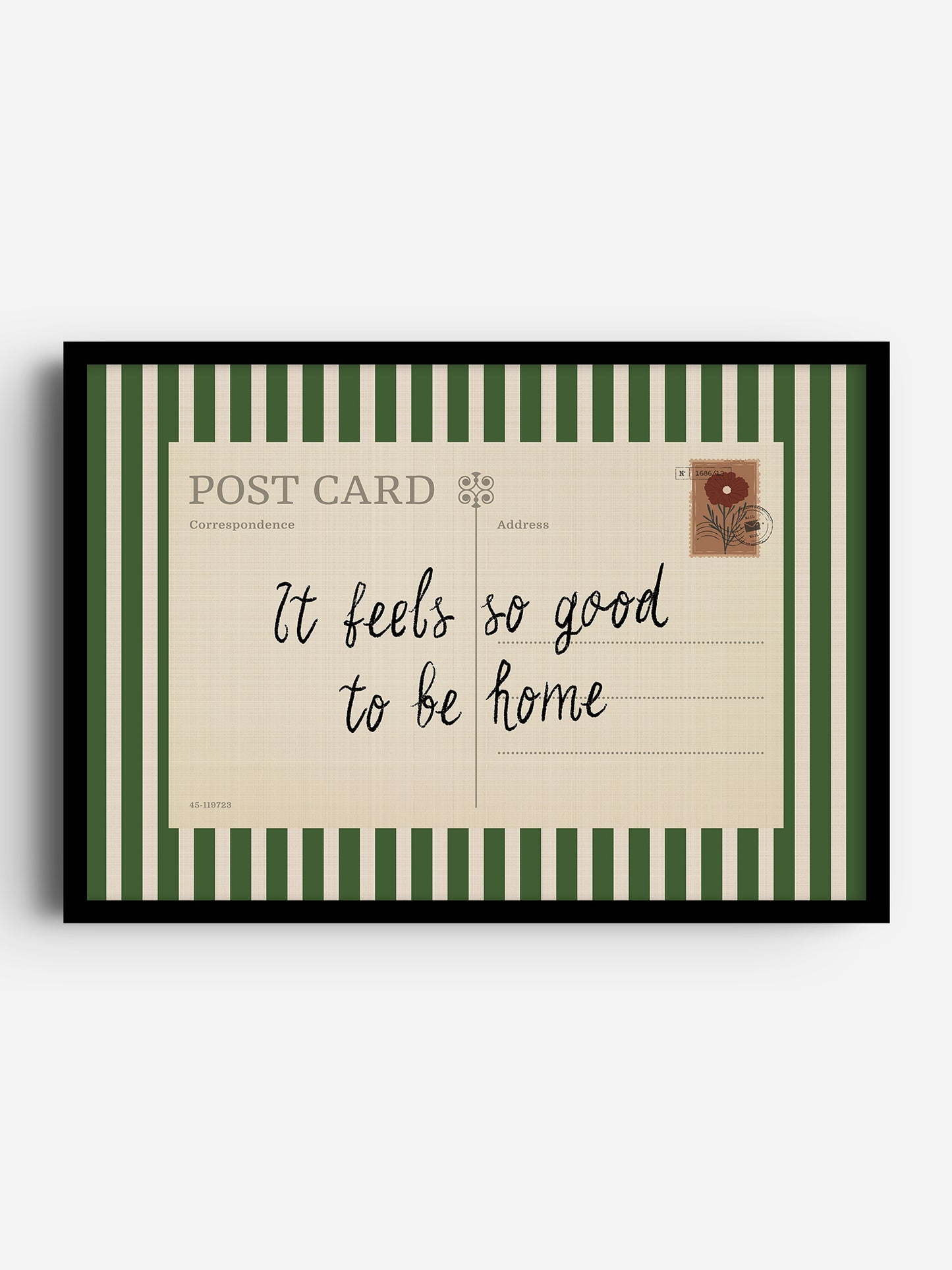 The image is a framed postcard with a green and white striped border. The postcard has a message that reads "It feels so good to be home" written in cursive.