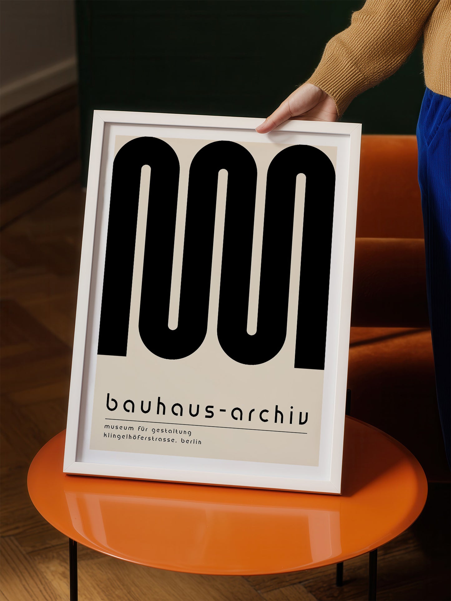 a person holding a framed poster with a large black text design on it.