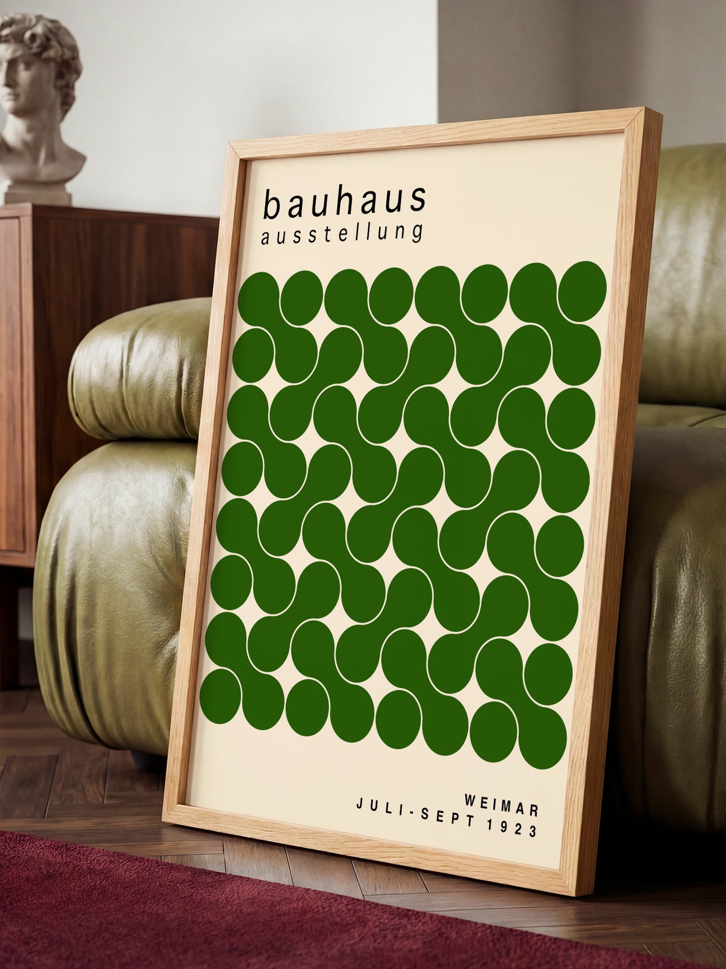 a framed poster of the Bauhaus art school, with a repeating pattern of green circles on a beige background.