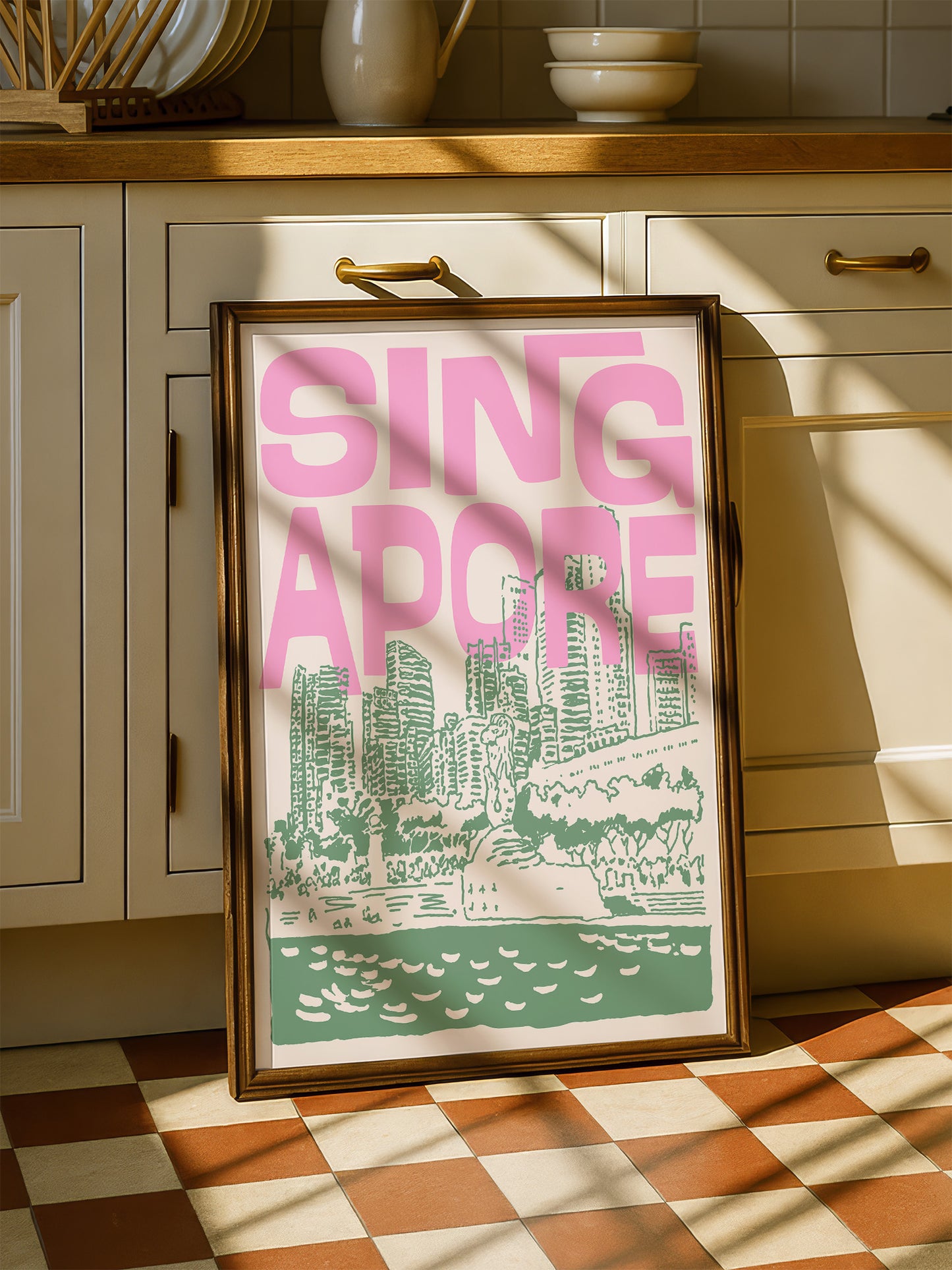 A framed poster of a cityscape with the text "SINGAPORE" prominently displayed, placed on a checkered floor in a kitchen setting.