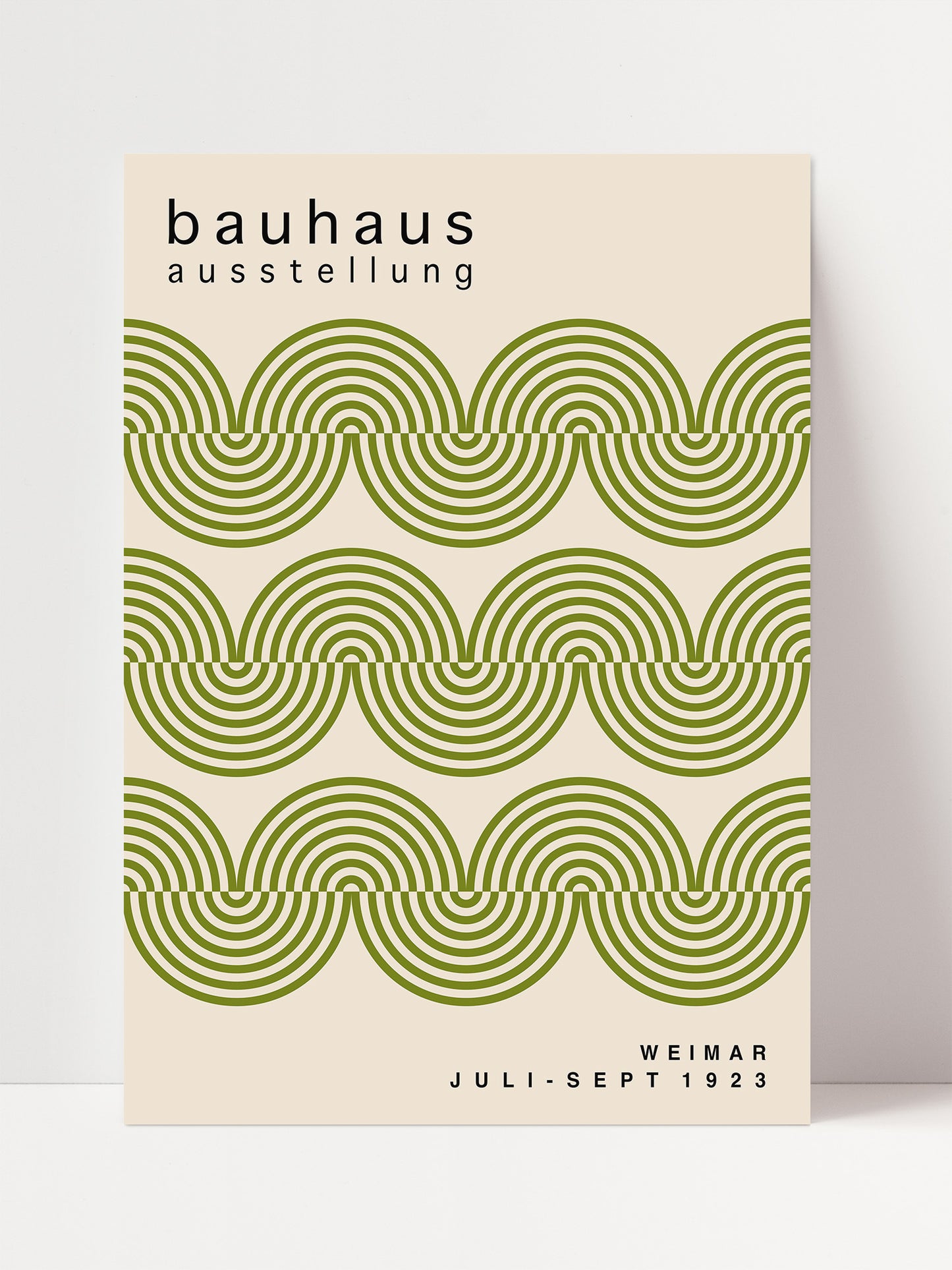 The image is a poster for the Bauhaus exhibition in Weimar, Germany, which took place from July to September 1923. The poster features a repeating pattern of green and white circles, creating a visually striking design.