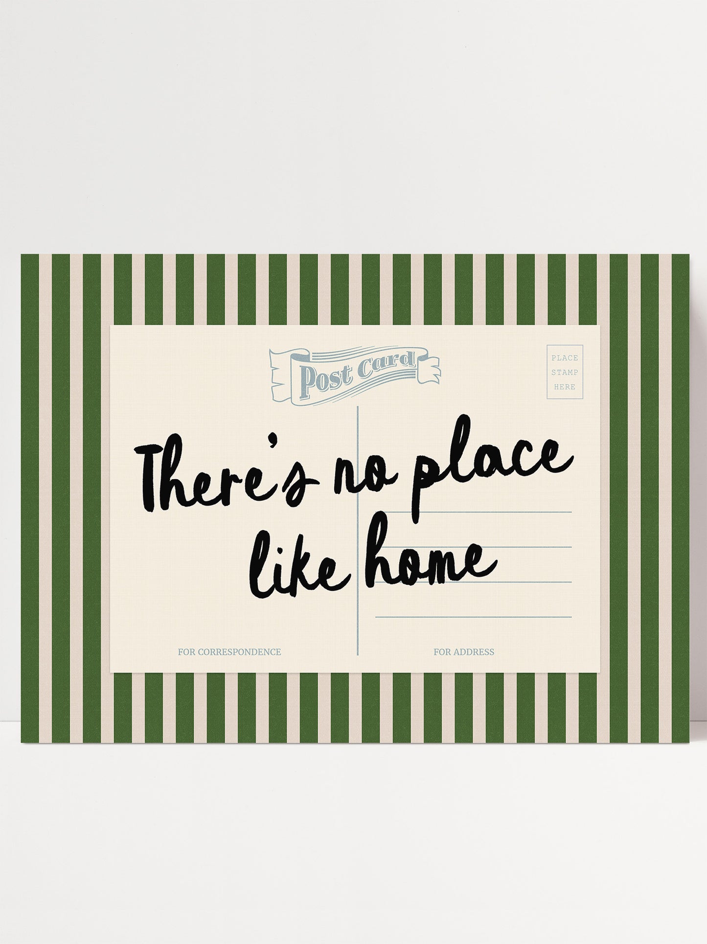 The image is a postcard with a green and white striped border. The postcard has a message that reads "There's no place like home" in black cursive text.