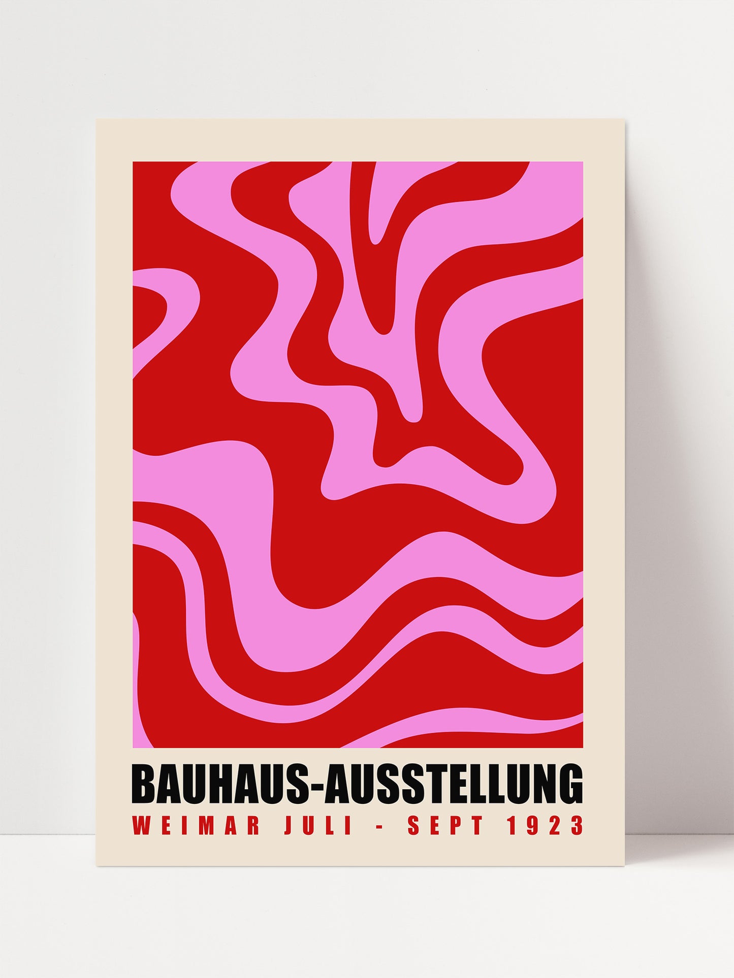 The image is a poster for the Bauhaus-Ausstellung, which was established in 1929. The poster features a bold, abstract design with red and pink swirls against a beige background.