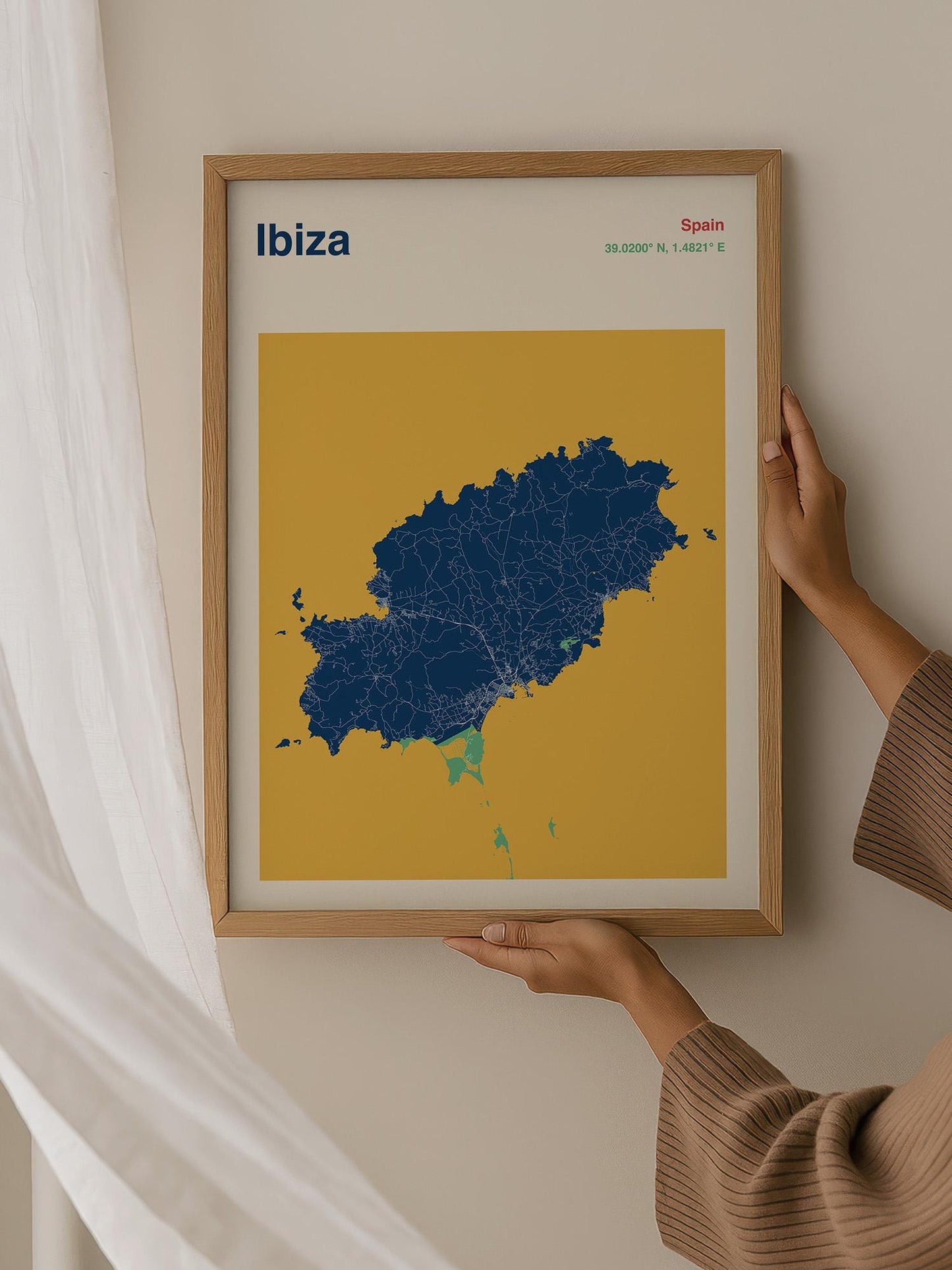 A person is holding a framed map of Ibiza, Spain, which is a map of the island of Ibiza.