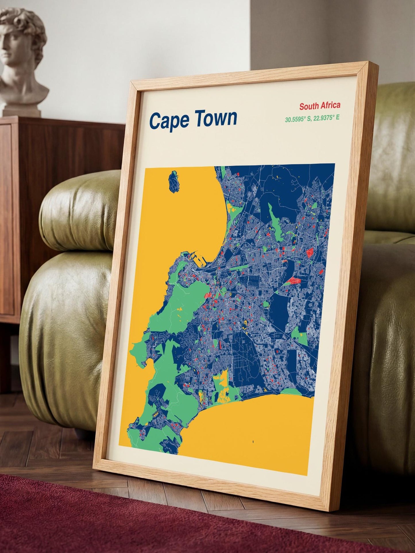 A framed map of Cape Town, South Africa, with a vibrant color scheme of blue, yellow, and green.