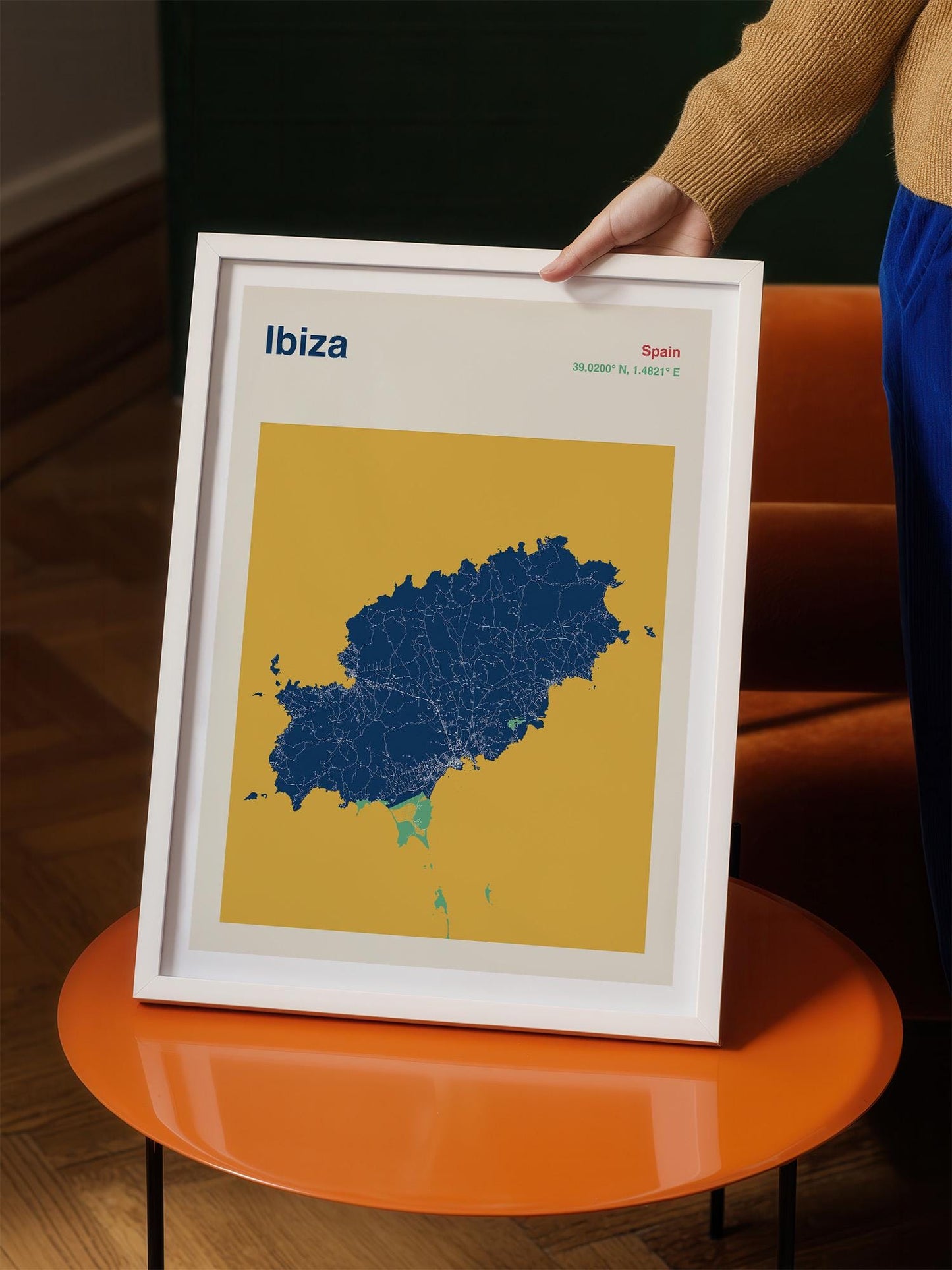 A person is holding a framed map of Ibiza, Spain, which is a map of the island of Ibiza.