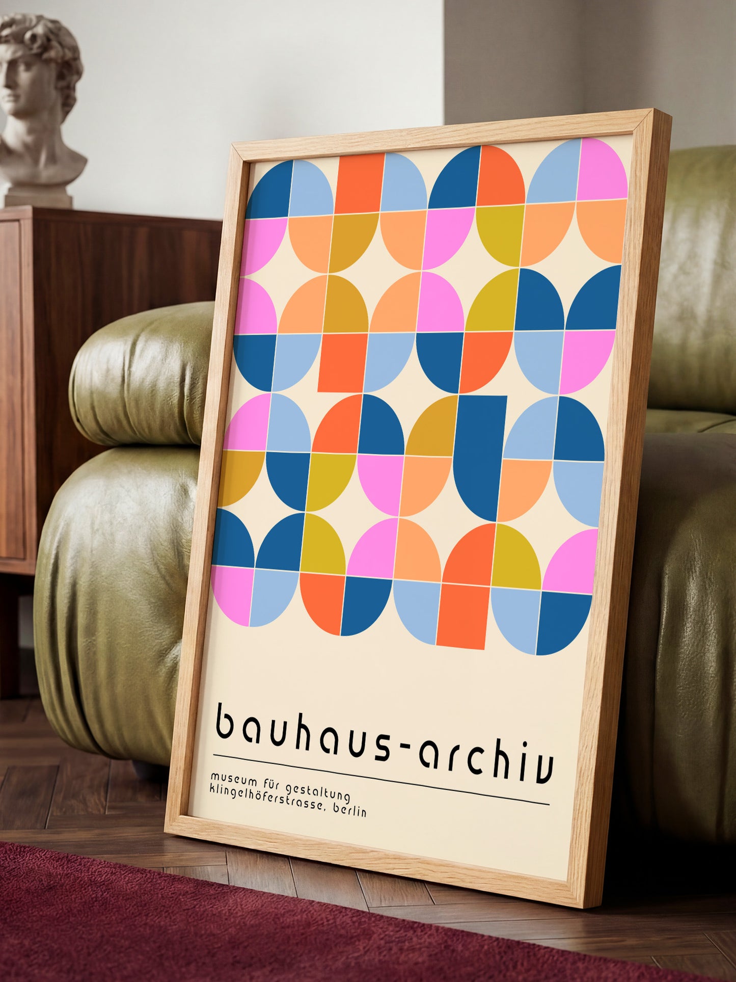 a poster with a geometric design of circles and squares, displayed on a wooden frame.