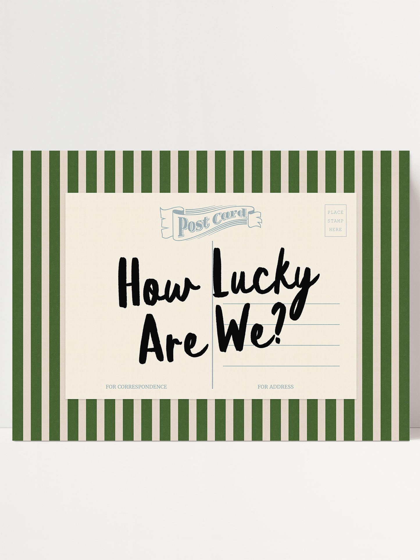 A postcard with a green and white striped border and the text "How Lucky Are We?" written on it.