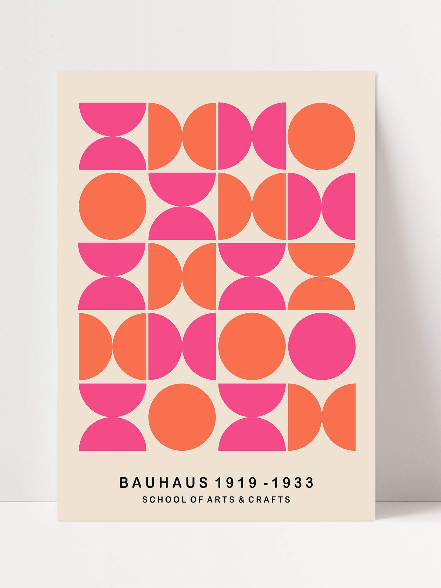 The image is a poster for the Bauhaus School of Arts and Crafts, featuring a geometric design with circles and ovals in various shades of pink and orange.