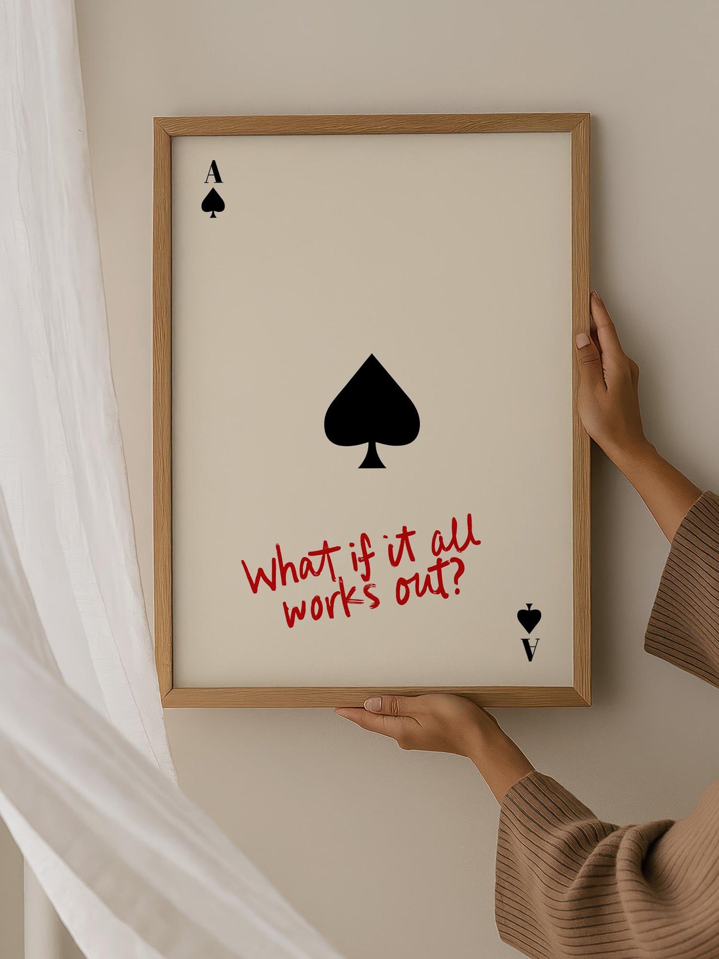 A person is holding a framed picture with a question written on it, which reads "What if it all works out?"