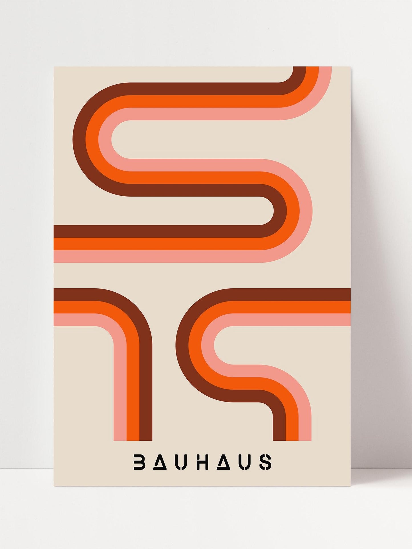 a minimalist design with a repeating pattern of curved lines in shades of orange and pink. The text "BAUHAUS" is prominently displayed below the design.