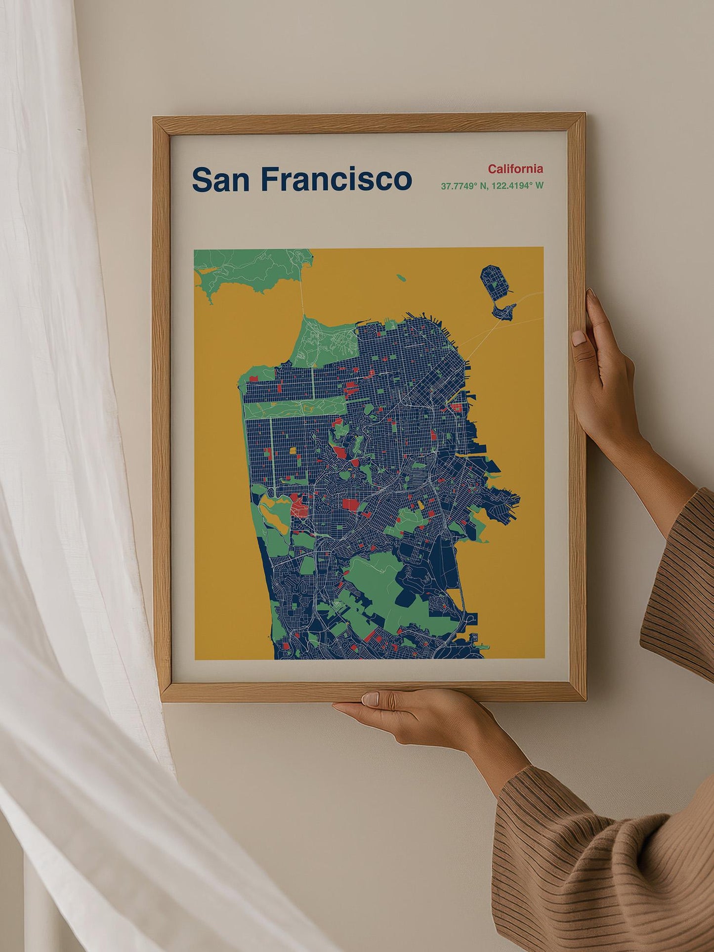 A person is holding up a framed map of San Francisco, California.