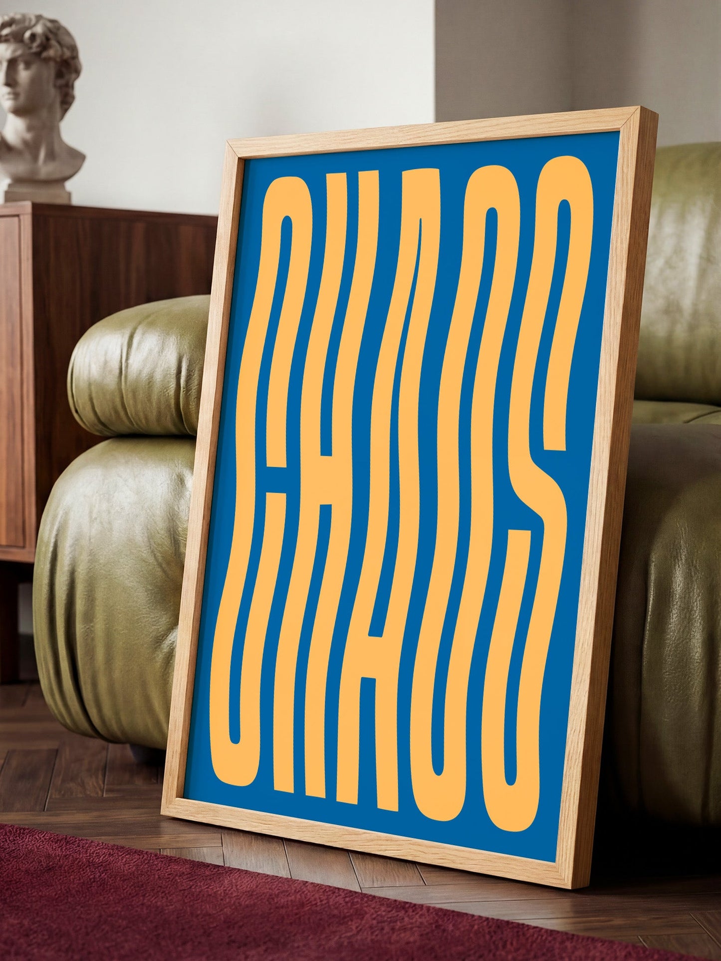a large framed poster with the word "CHAOS" written in a bold, stylized font on a blue background.