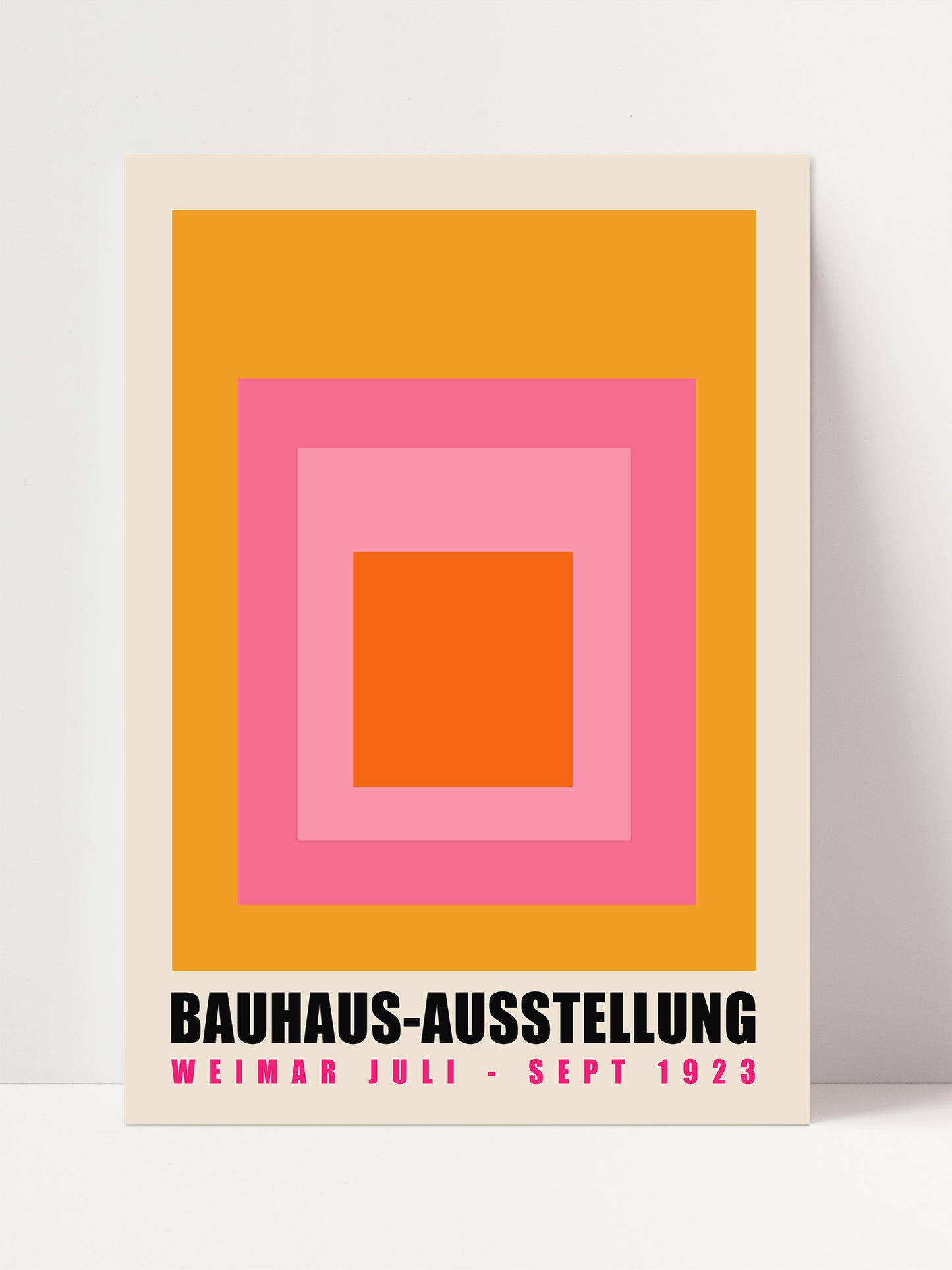 A poster for the Bauhaus-Ausstellung, which was held in Weimar, Germany from September 1925. The poster features a bold geometric design with a large square in the center, surrounded by smaller squares in shades of pink and orange.