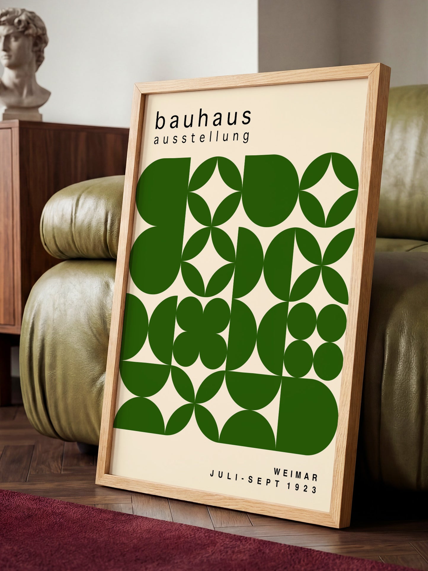 a framed poster of the Bauhaus art school, with a geometric design in shades of green and white.