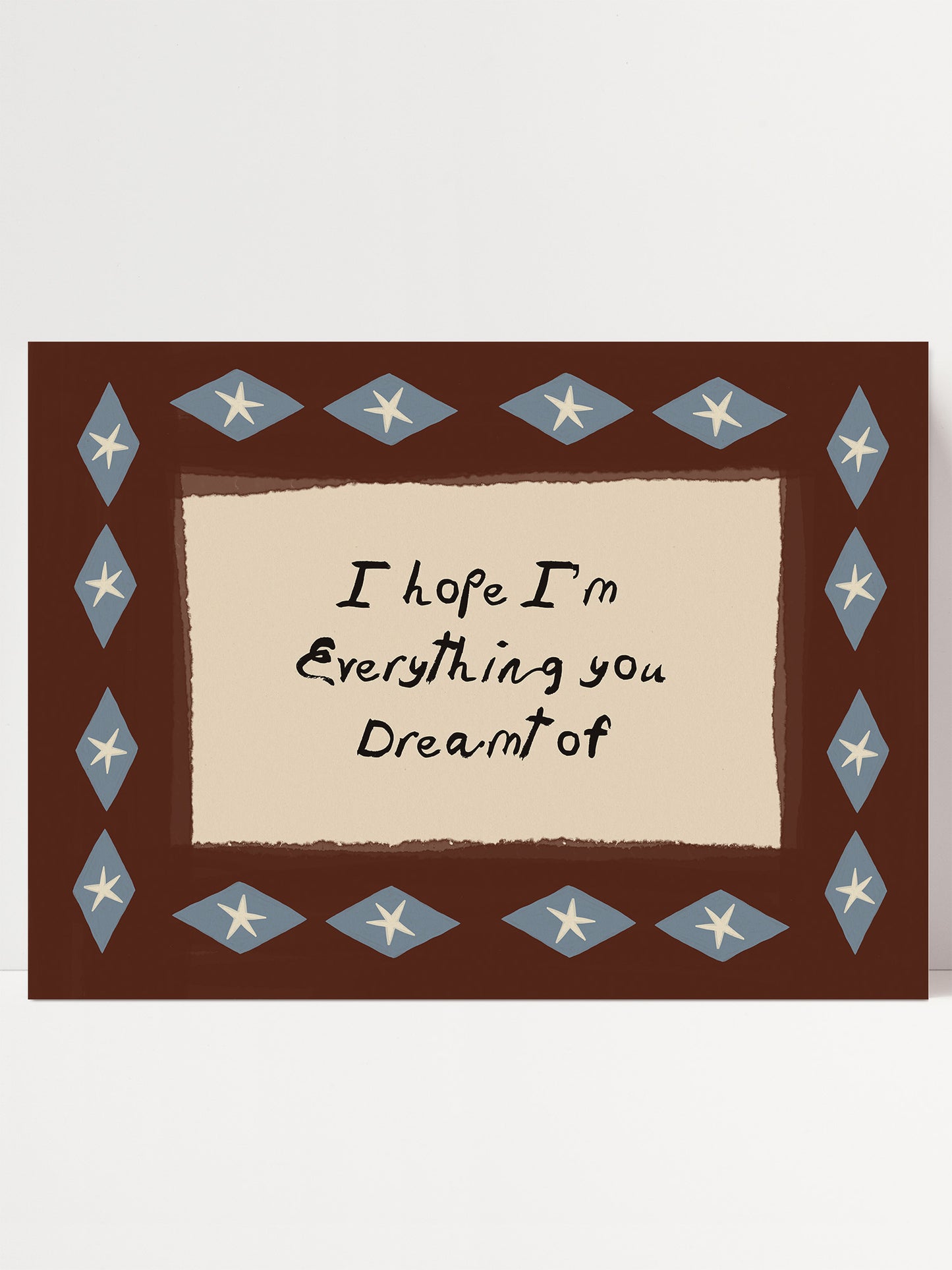 a framed message with a brown border and blue diamond shapes, and the message is written in black cursive font.