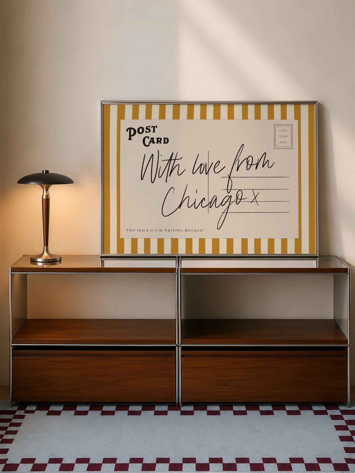 a wooden cabinet with a lamp on top, and a framed postcard with handwritten text on it, which reads "With love from Chicago x".