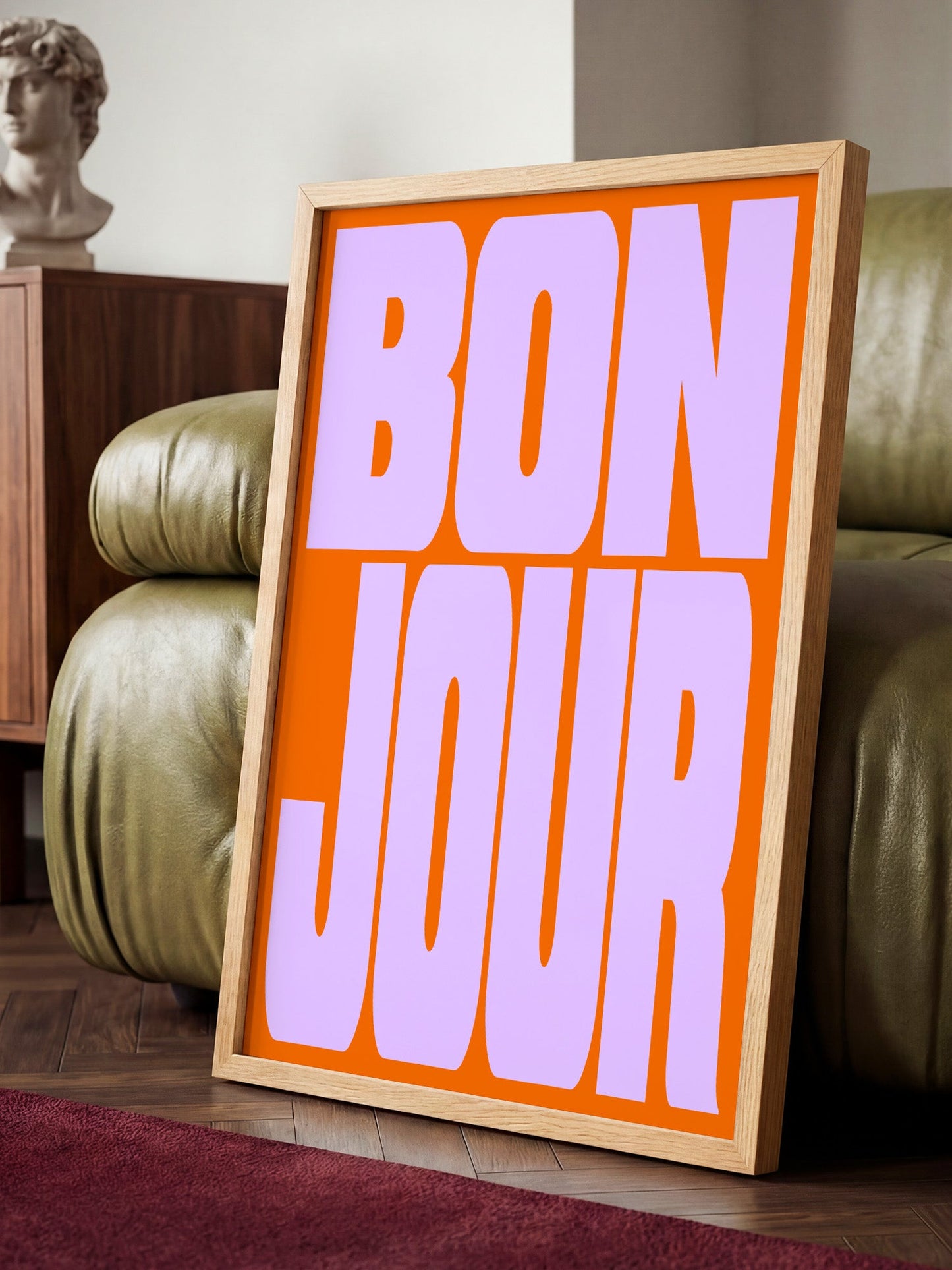 a large orange sign with the text " bon jour" in bold purple letters.