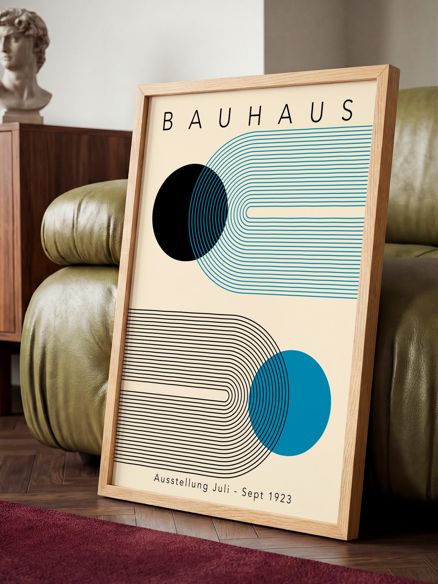 a framed poster of the Bauhaus art school, with a minimalist design of geometric shapes and lines in shades of blue and gray.