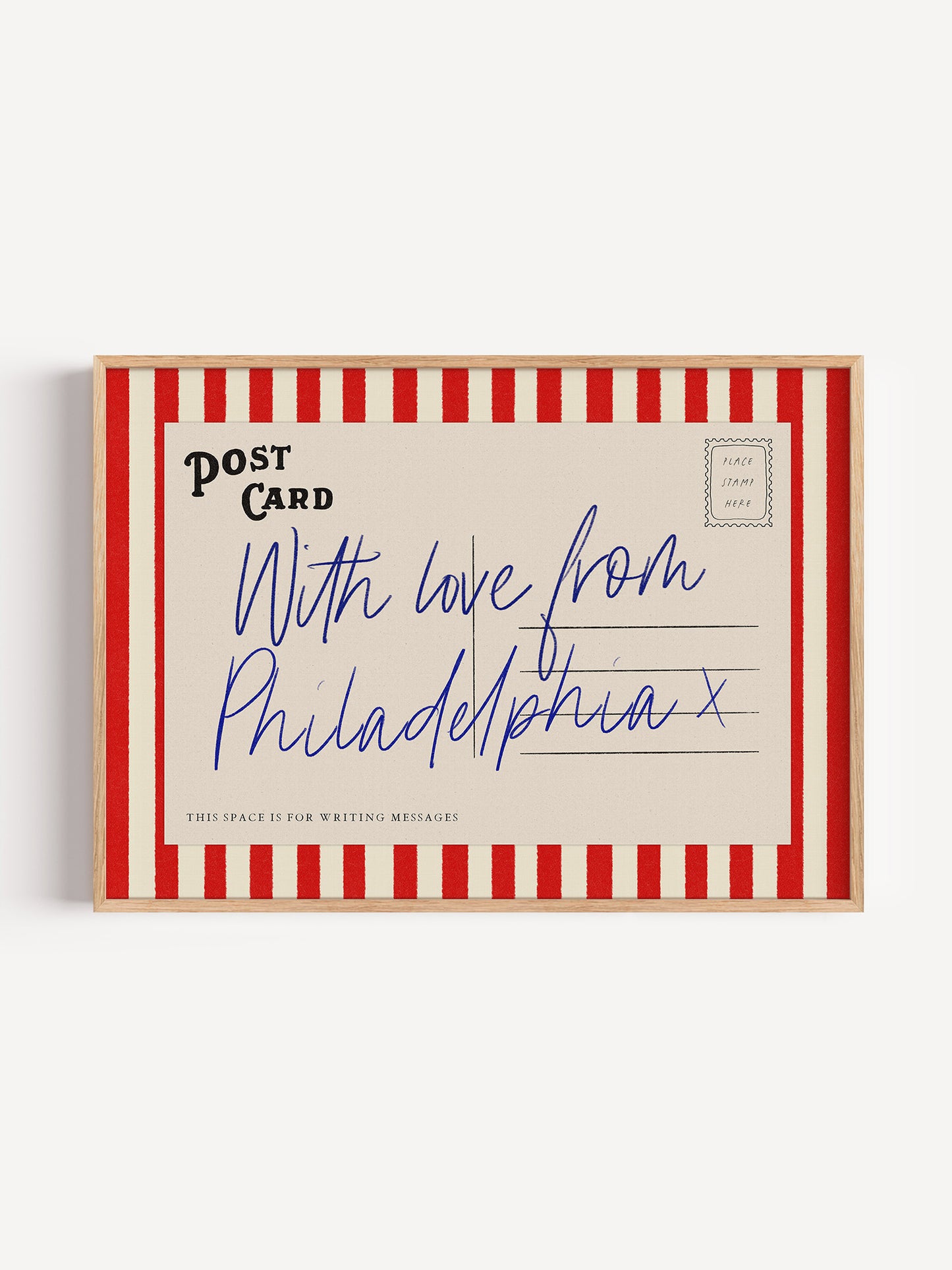A framed postcard with a handwritten message that reads "With love from Philadelphia".