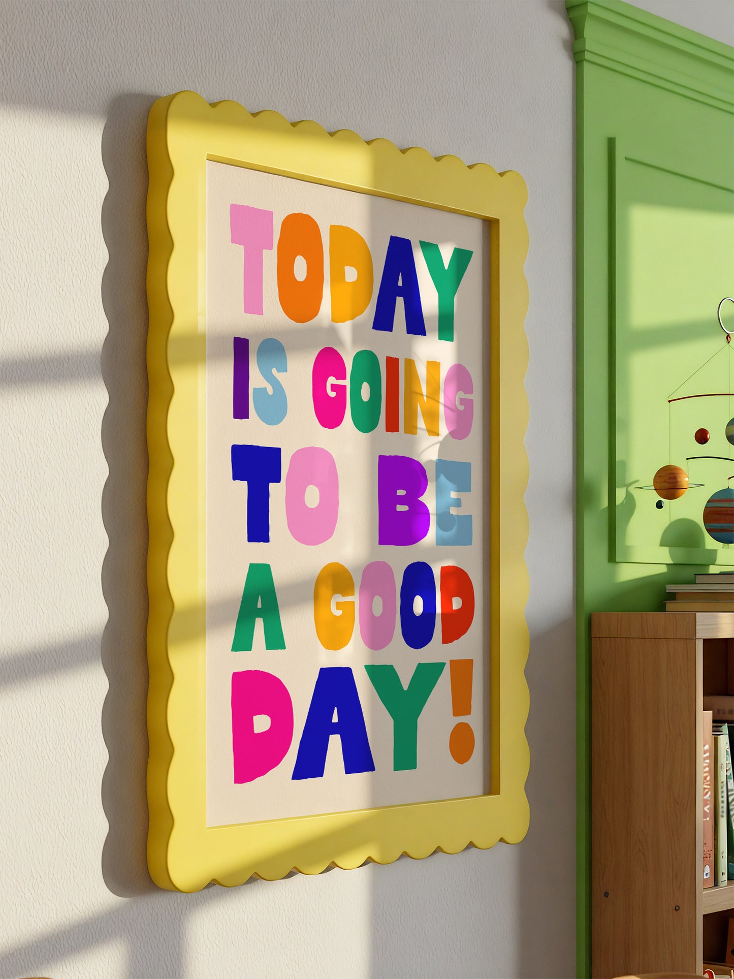 A framed poster with the text "TODAY IS GOING TO BE A GOOD DAY!" displayed on a wall.