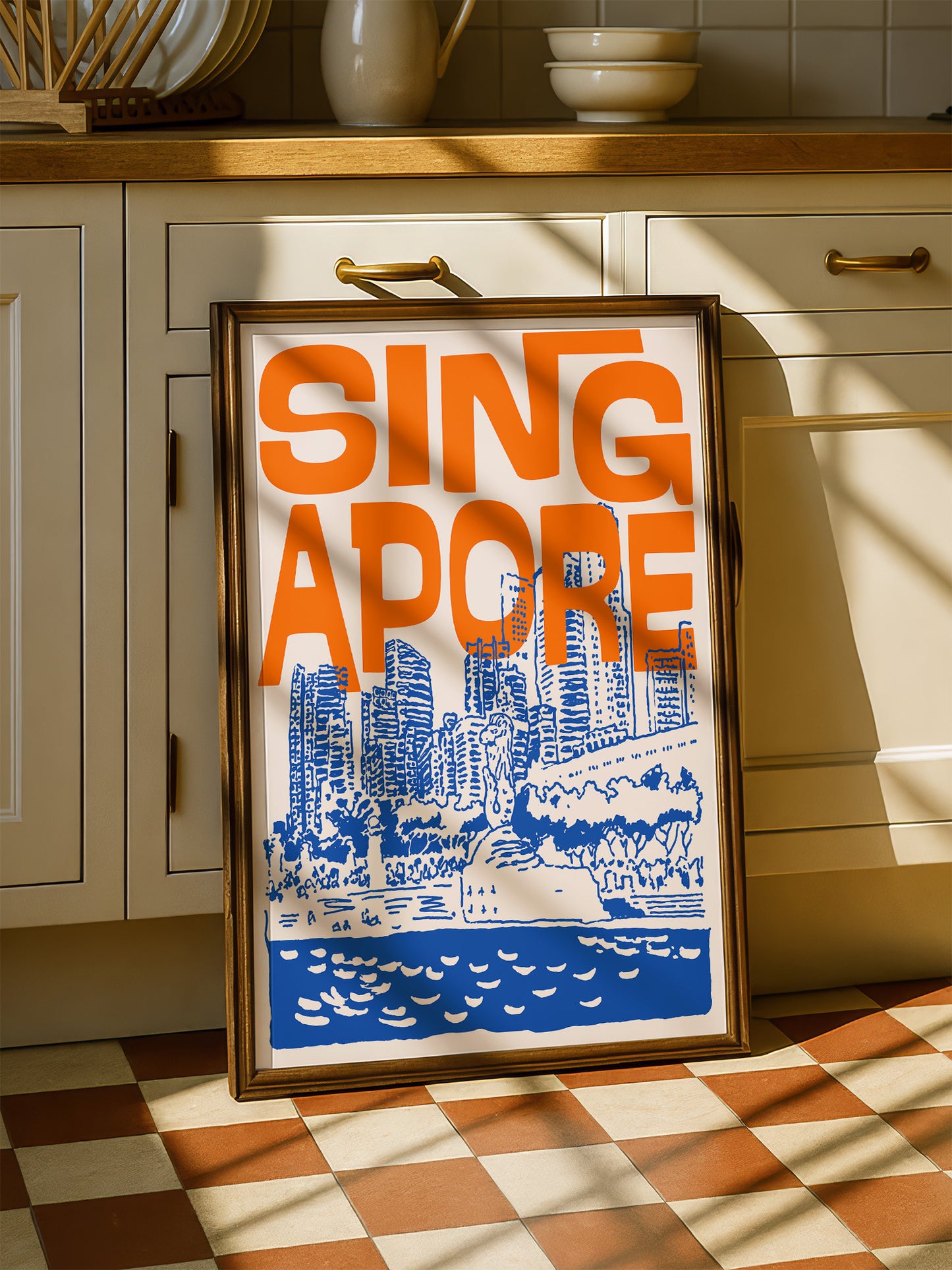 A framed poster of a cityscape with the text "SINGAPORE" prominently displayed, sitting on a checkered floor in a kitchen setting.
