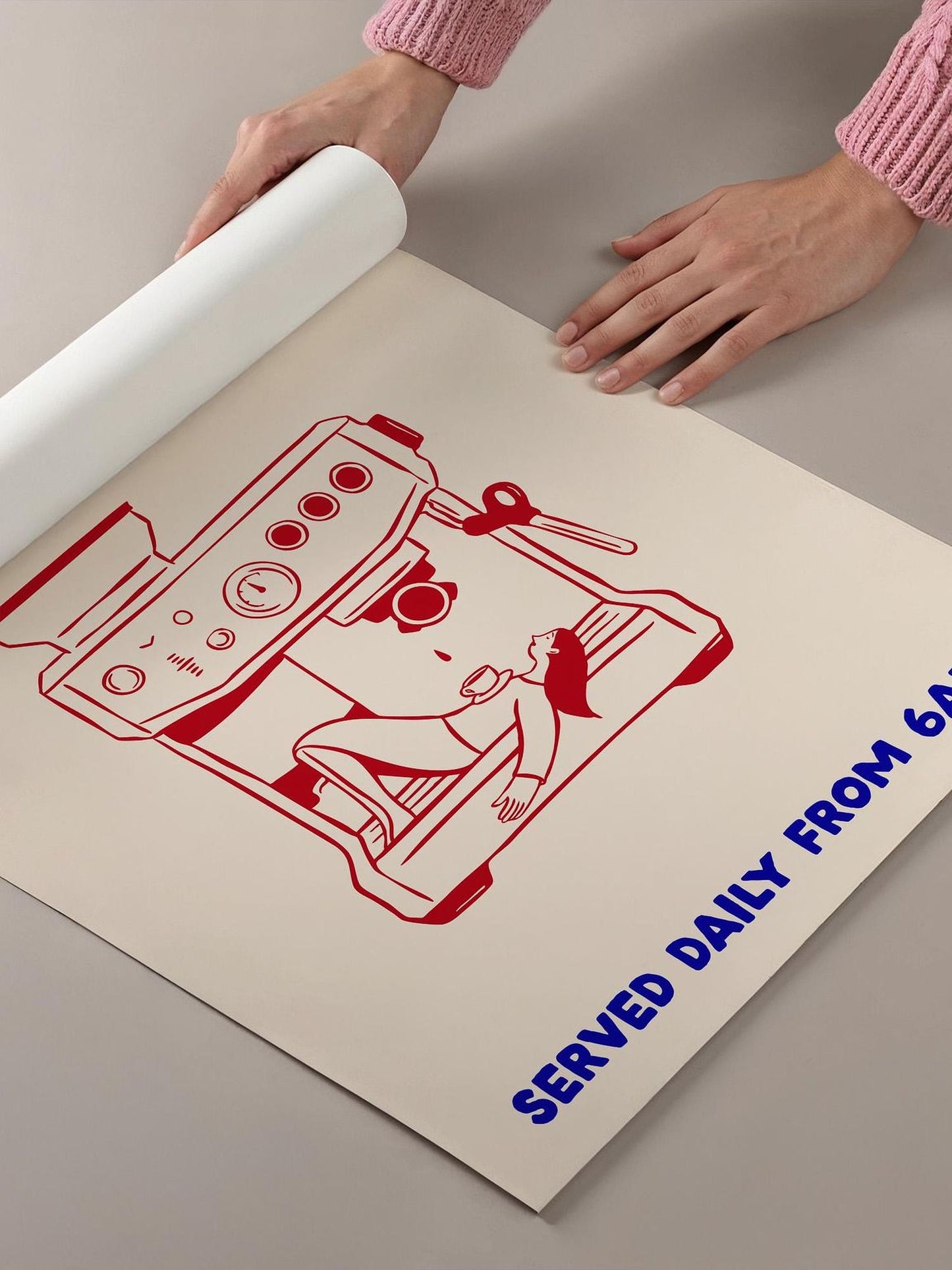 a person's hands holding a roll of paper, with a printed image of a coffee machine on it.