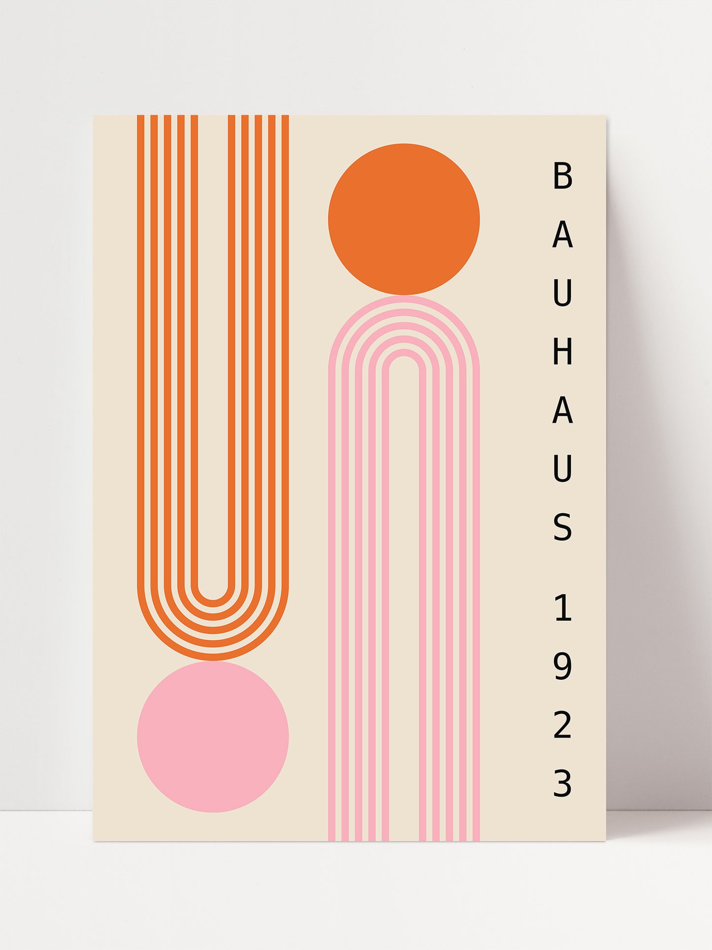 The image is a poster for the Bauhaus exhibition, featuring abstract geometric designs in shades of pink, orange, and white.
