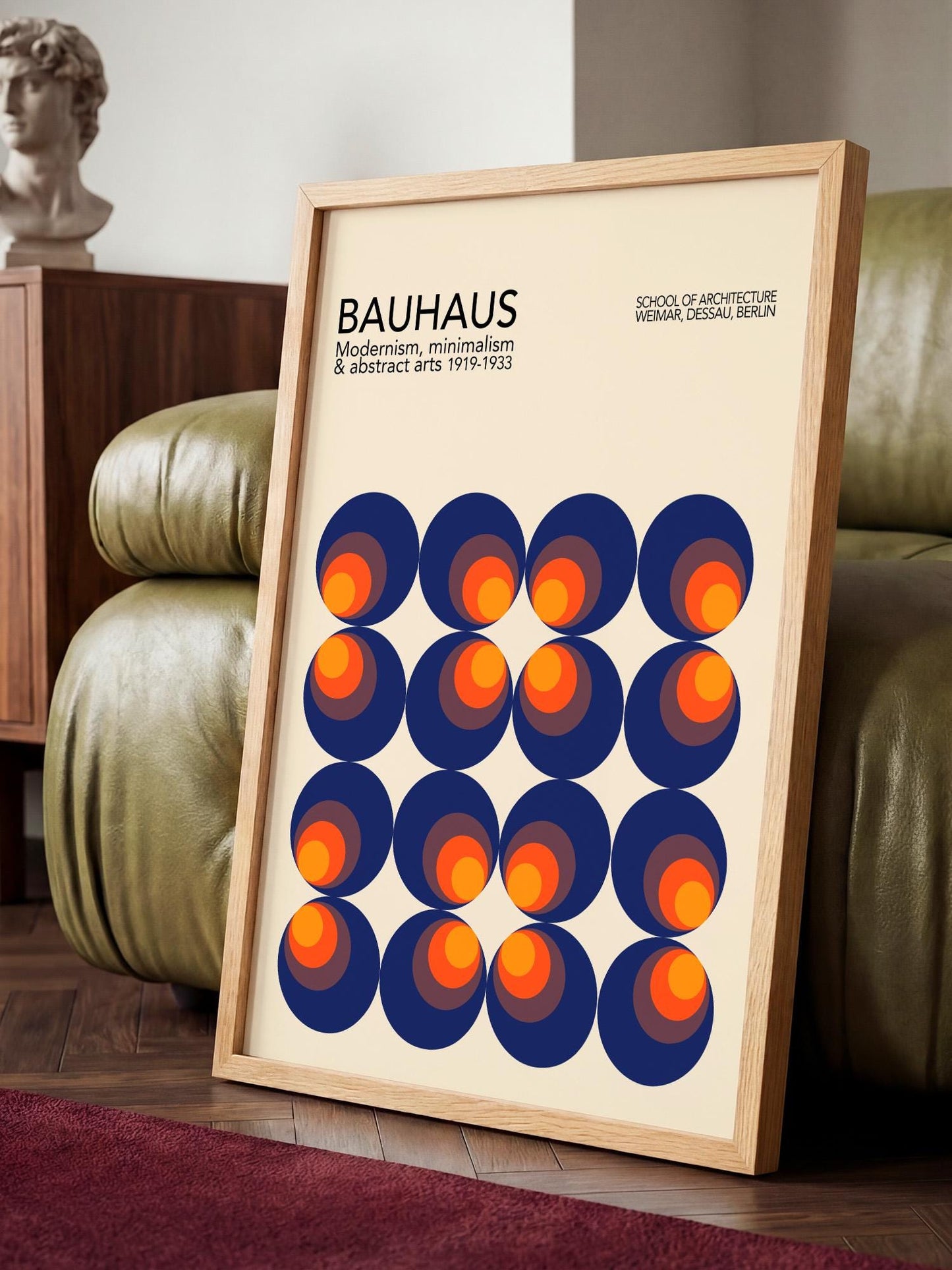 a framed poster of the Bauhaus school of architecture, showcasing a repeating pattern of circles in shades of blue, orange, and red.