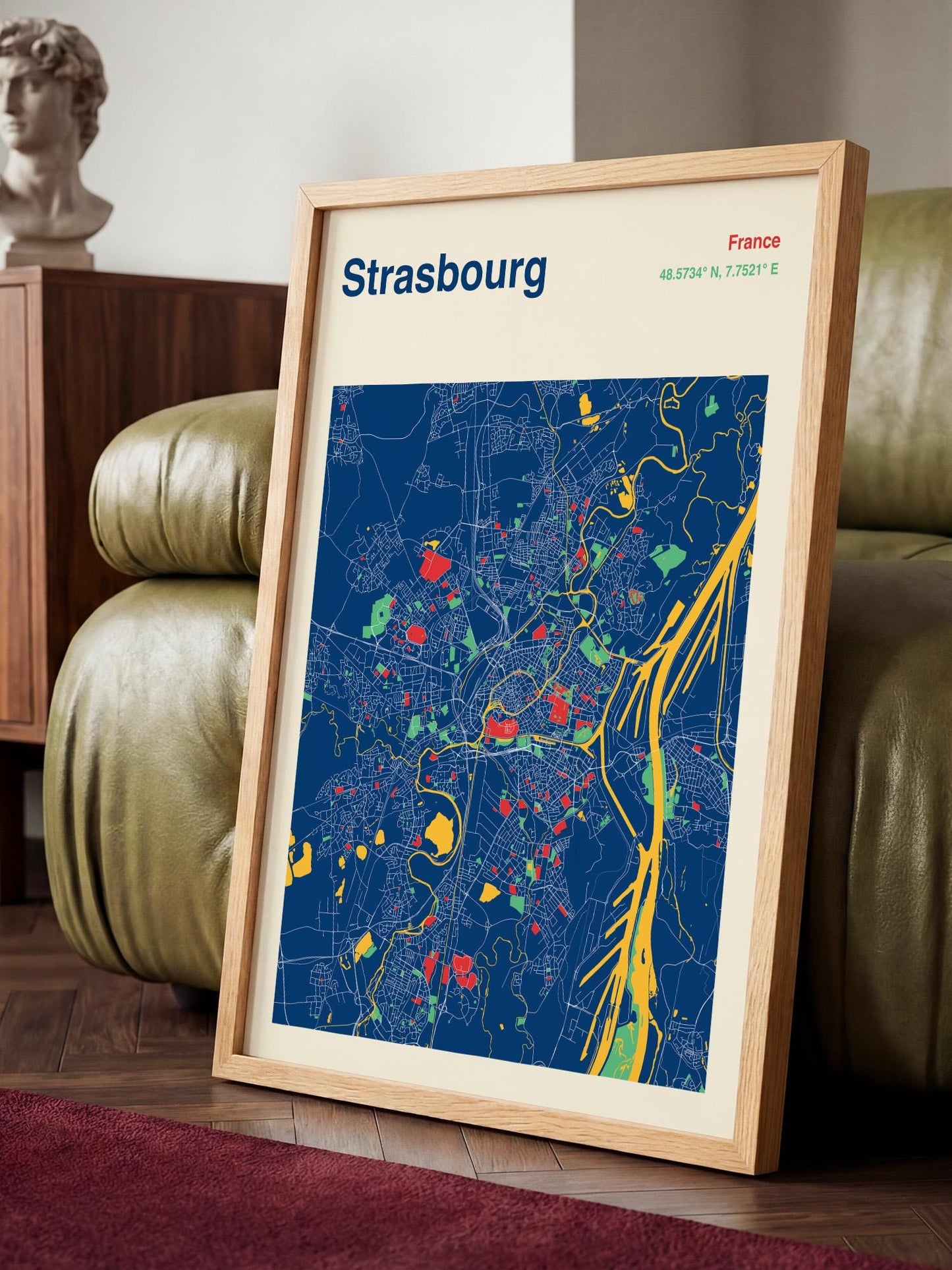 A framed map of the city of Strasbourg, France, with a colorful and detailed representation of the city's streets and landmarks.