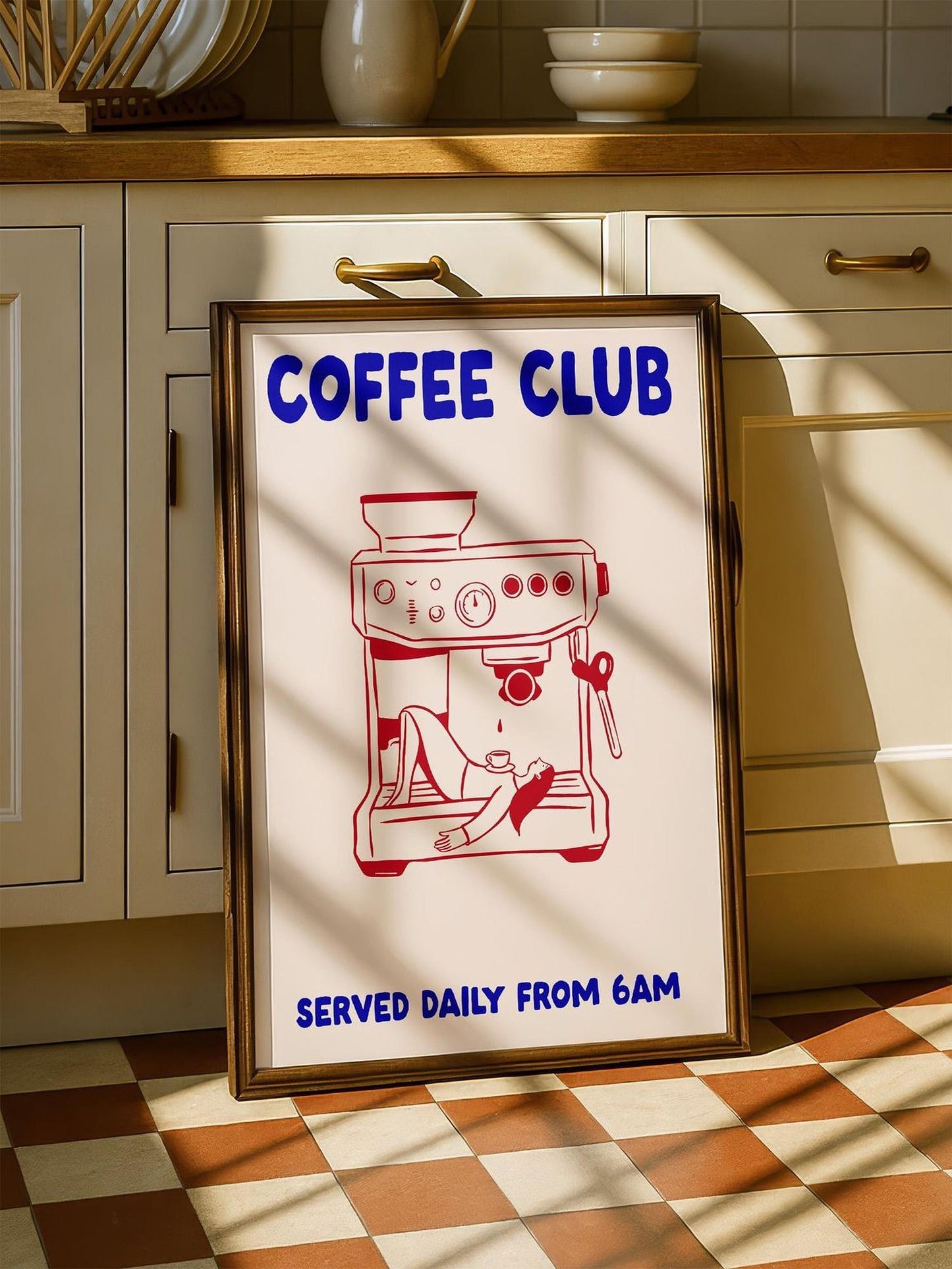 A framed poster advertising a coffee club, featuring an illustration of a coffee machine with a person sitting inside.