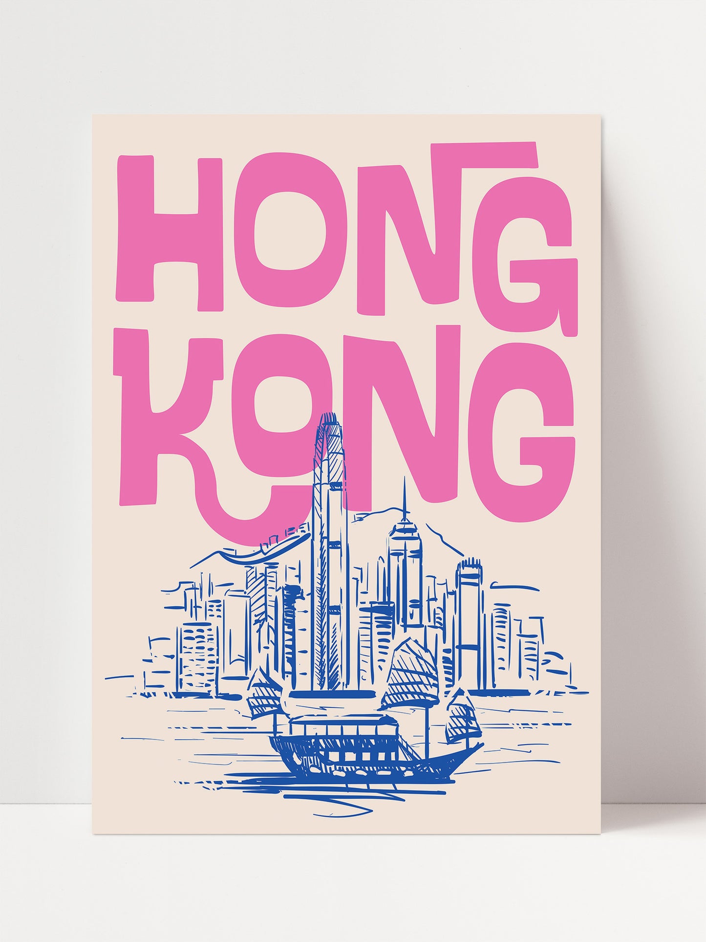 a poster with the text "HONG KONG" in large pink letters, along with a drawing of a cityscape and a boat.