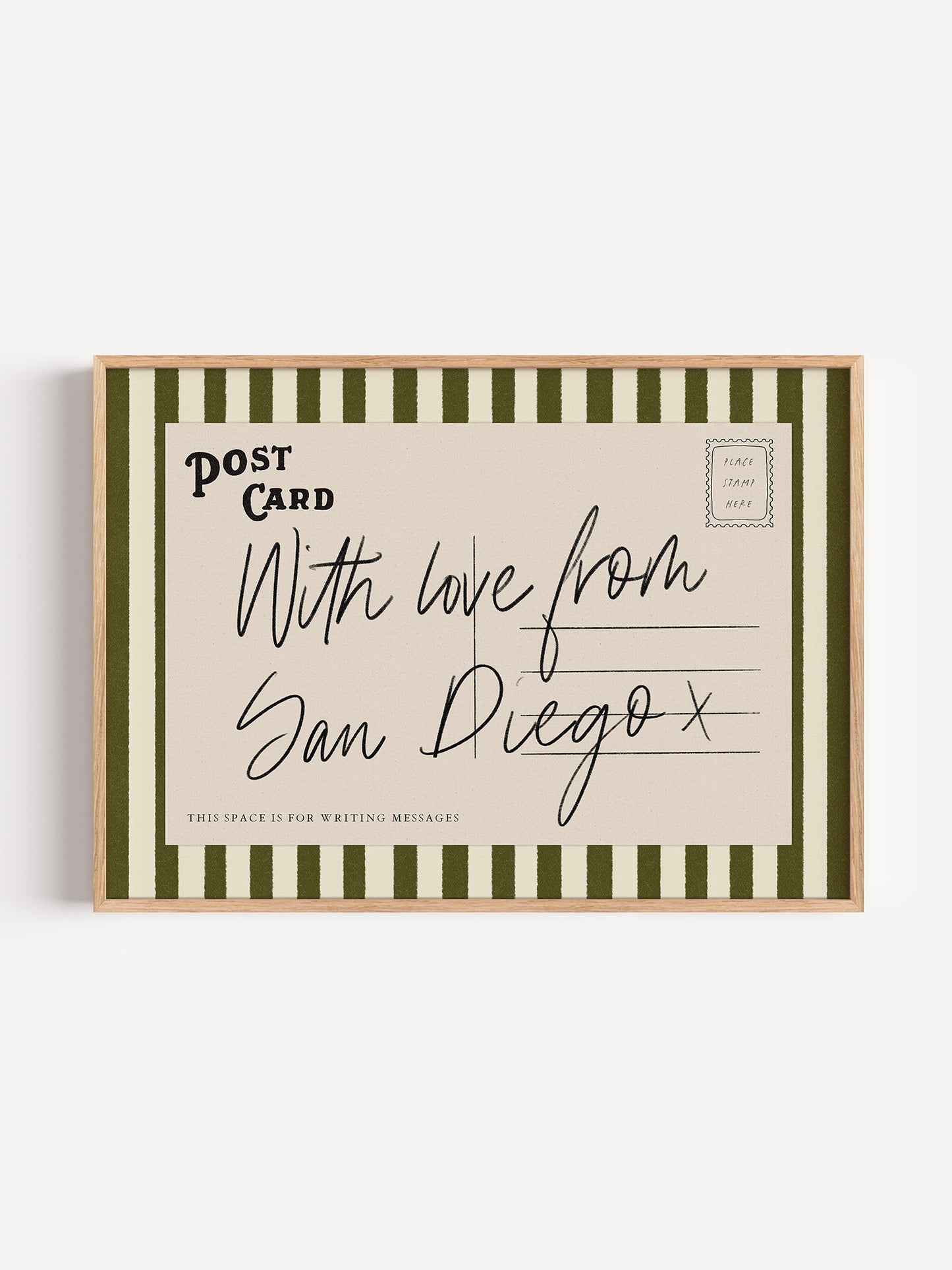 A framed postcard with handwritten text that reads "With love from San Diego x" and "This space is for writing messages".