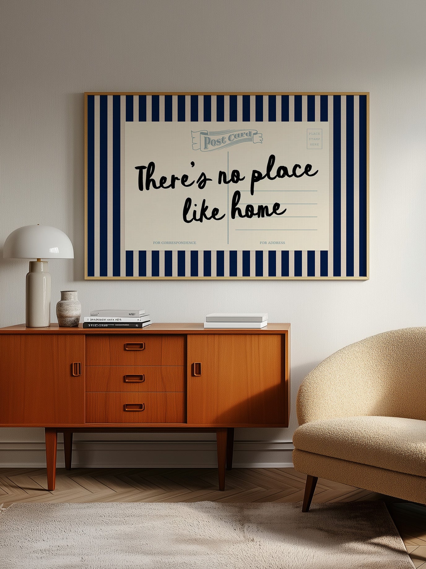 a vintage-style wooden cabinet with a blue and white striped frame, a lamp, a sofa, and a framed poster with the text "There's no place like home" on the wall.