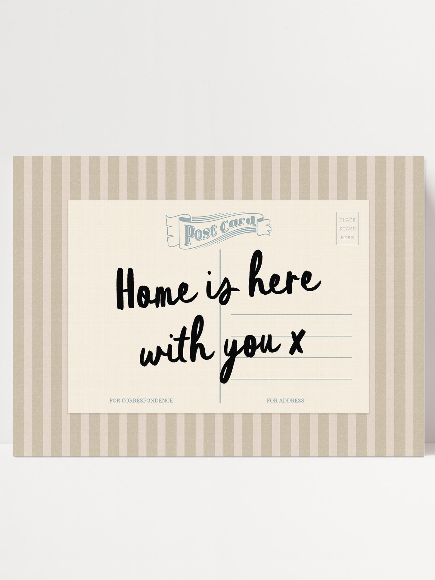A postcard with a message that reads "Home is here with you x" in a striped design.